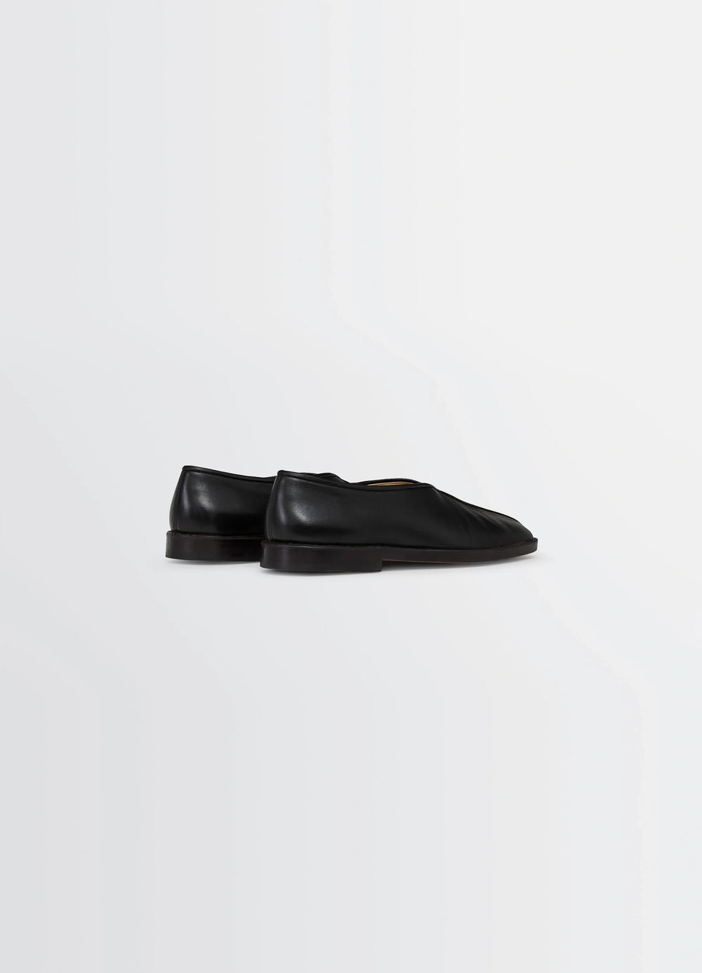 Lemaire Piped Slippers in Black Nappa Leather, product shot, back three-quarter view seamless leather back