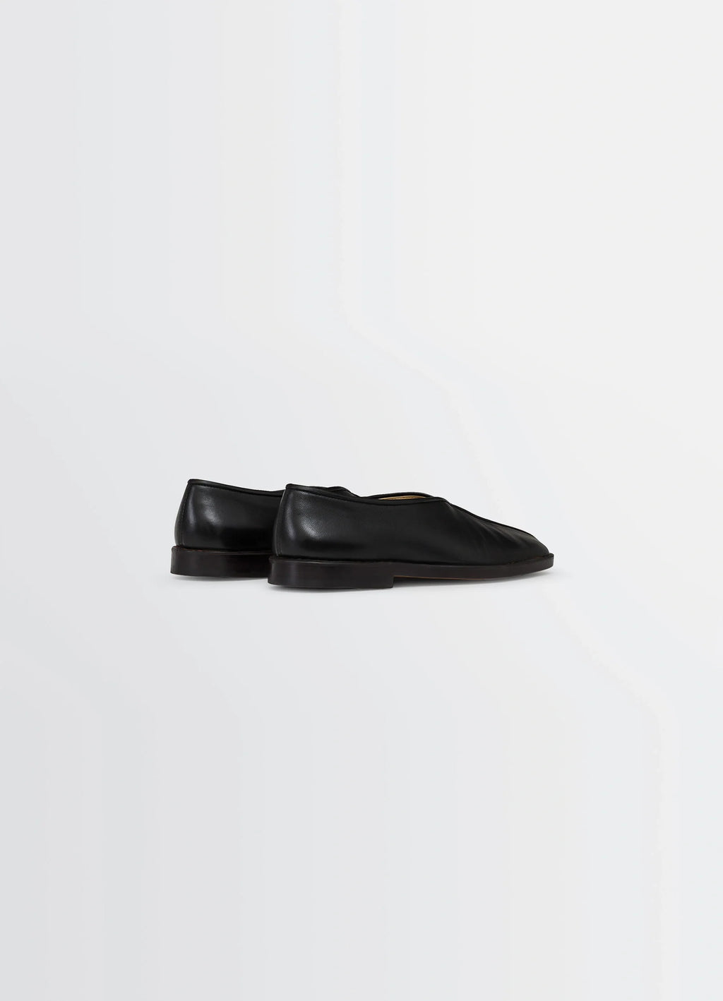 Lemaire Piped Slippers in Black Nappa Leather, product shot, back three-quarter view seamless leather back