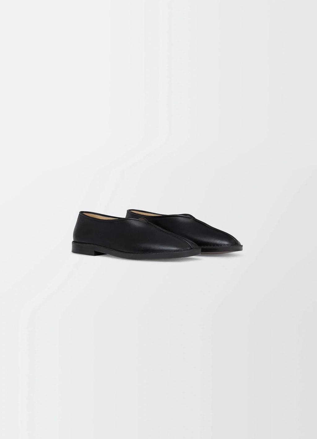 Lemaire Piped Slippers in Black Nappa Lamb Leather, product shot, three-quarter view leather piping detail