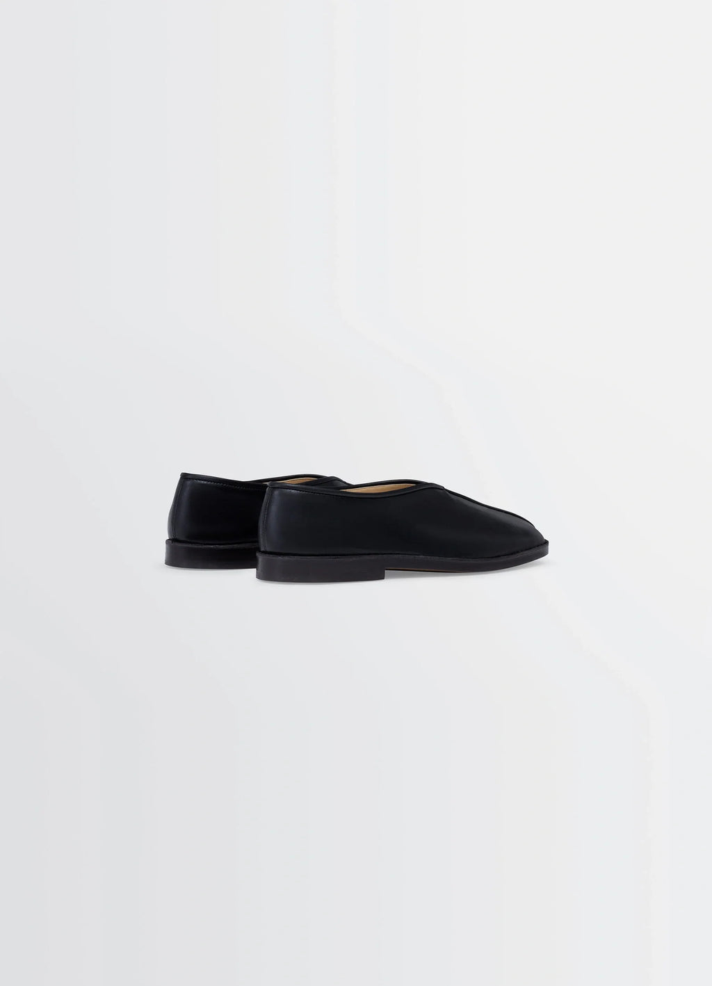 Lemaire Piped Slippers in Black Nappa Lamb Leather, product shot, rear three-quarter view minimal heel detail