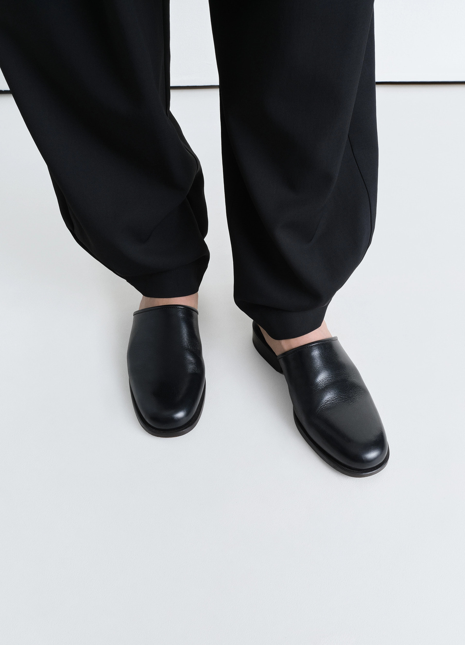 Lemaire square mule in shiny buffalo leather, model shot, top view worn with loose pants
