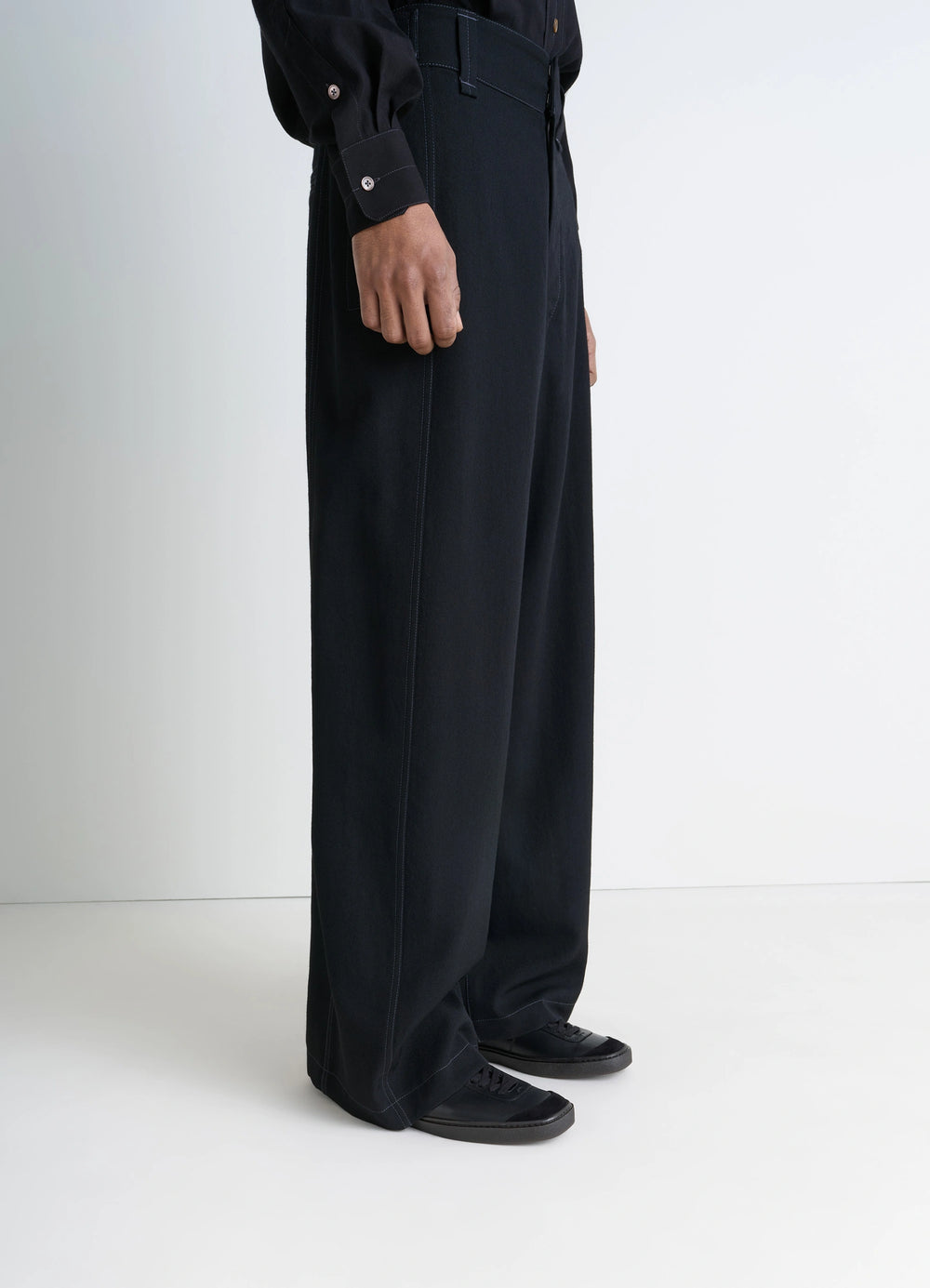 Linoelum Basic Laced Up Trainers in Black Soft Cow Leather, model shot, three-quarter view snug fit with rubber soles