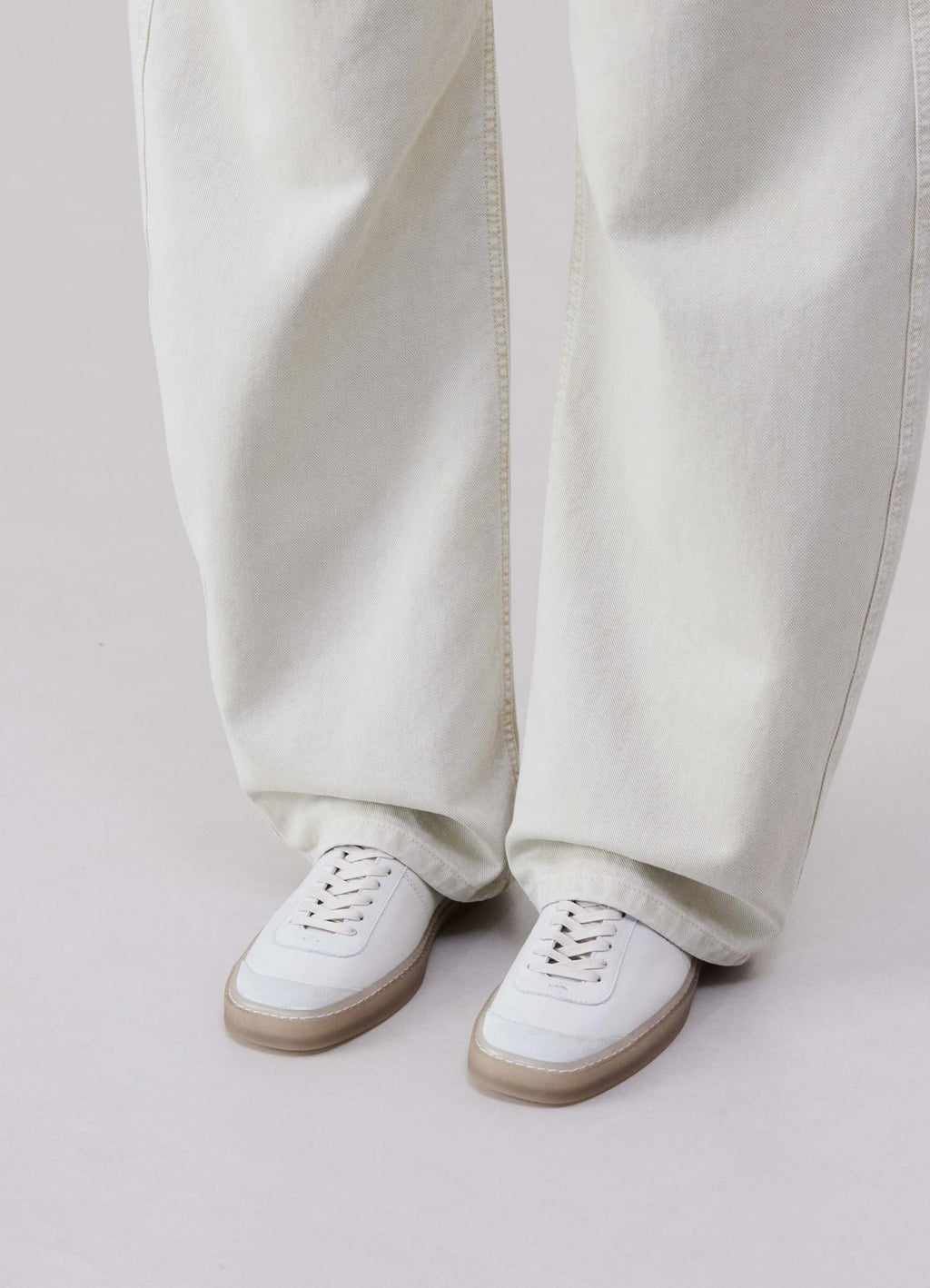 Lemaire Basic Laced Up Trainers in Smooth soft cow leather, model shot, front view tight lacing visible