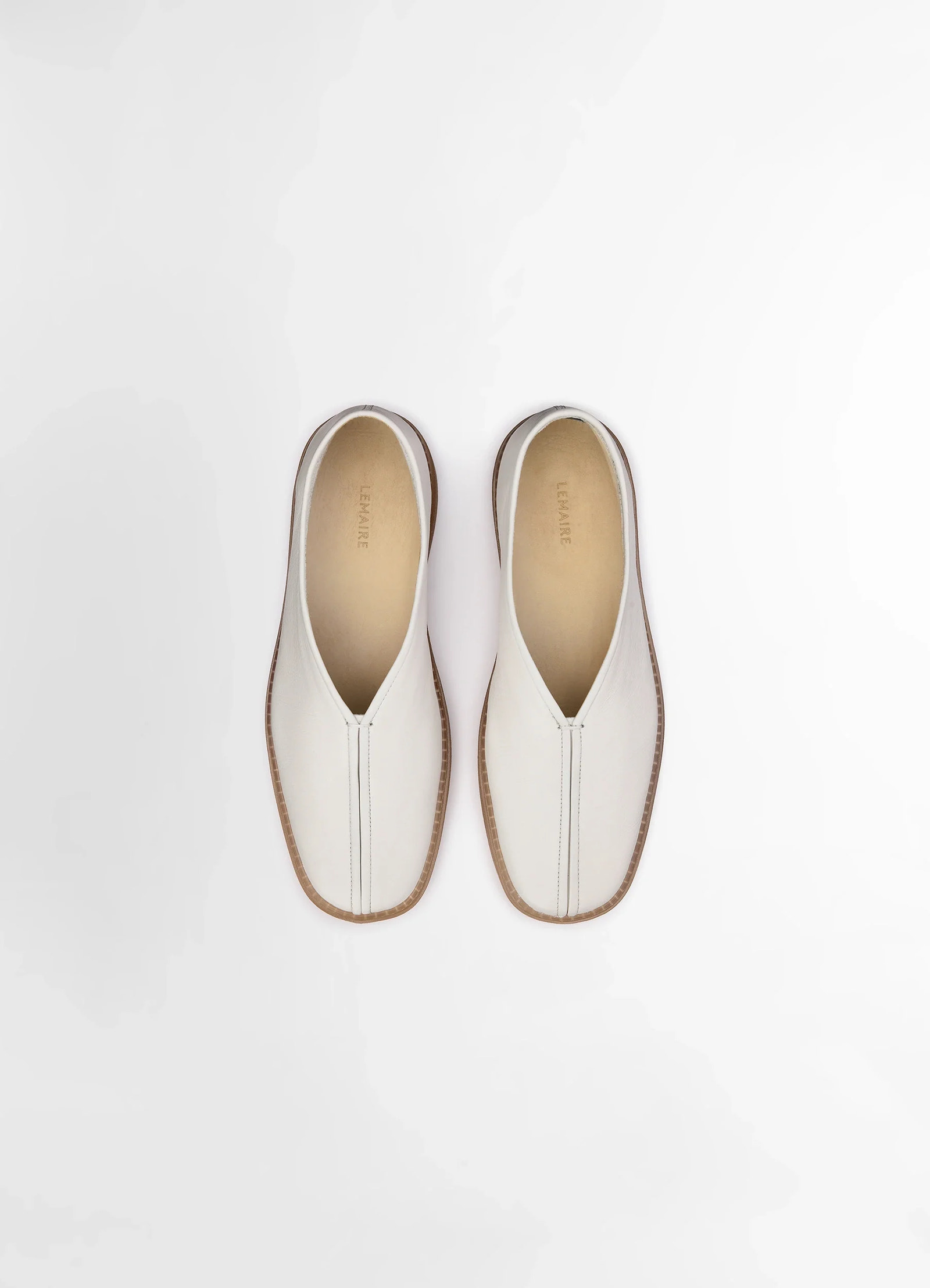 Lemaire linoleum piped sneakers in smooth soft cow leather, product shot, detail top down view central seam stitching