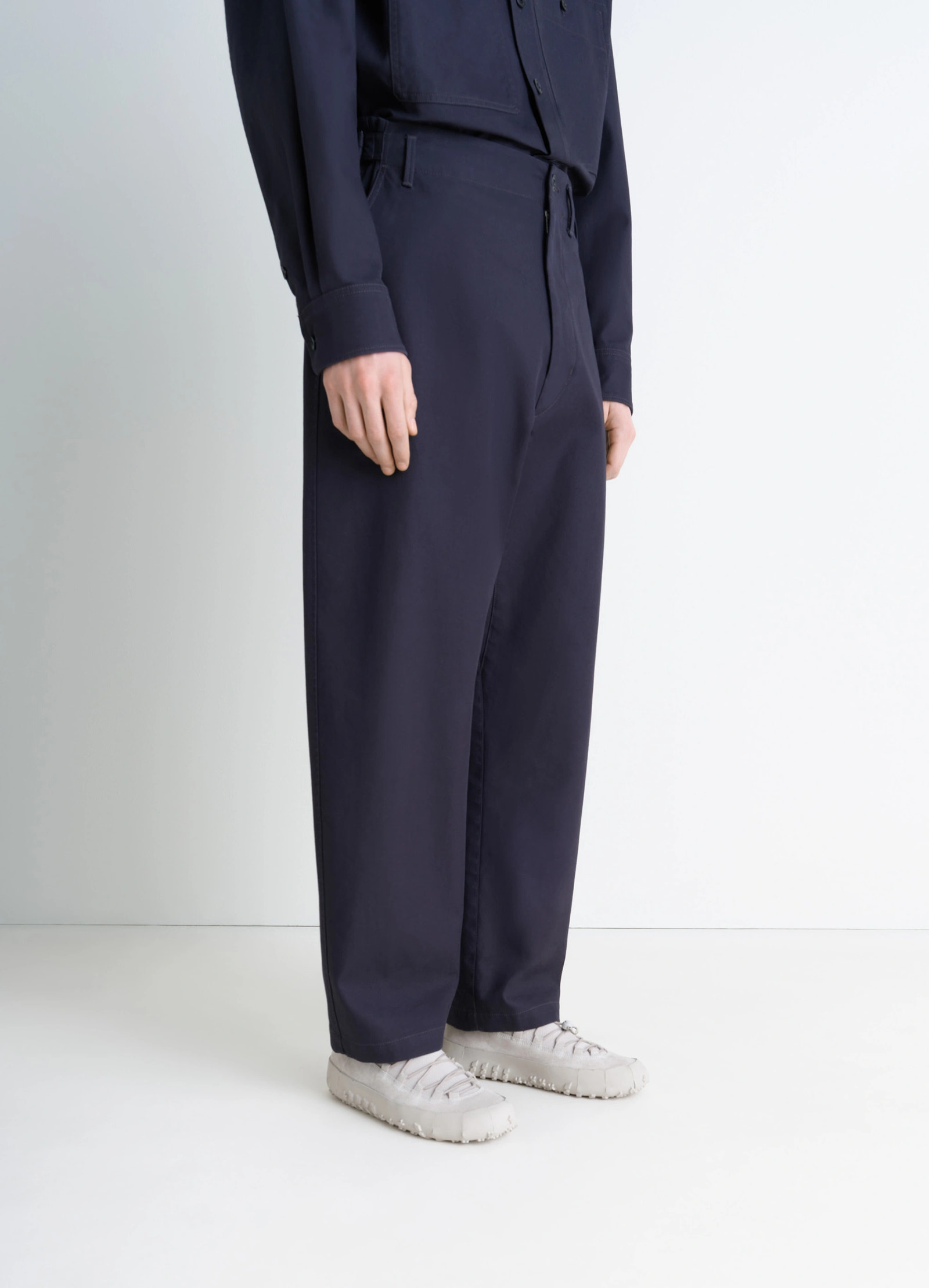 Vibram wrap on sneakers in navy and off-white, model shot, side view wide leg pants