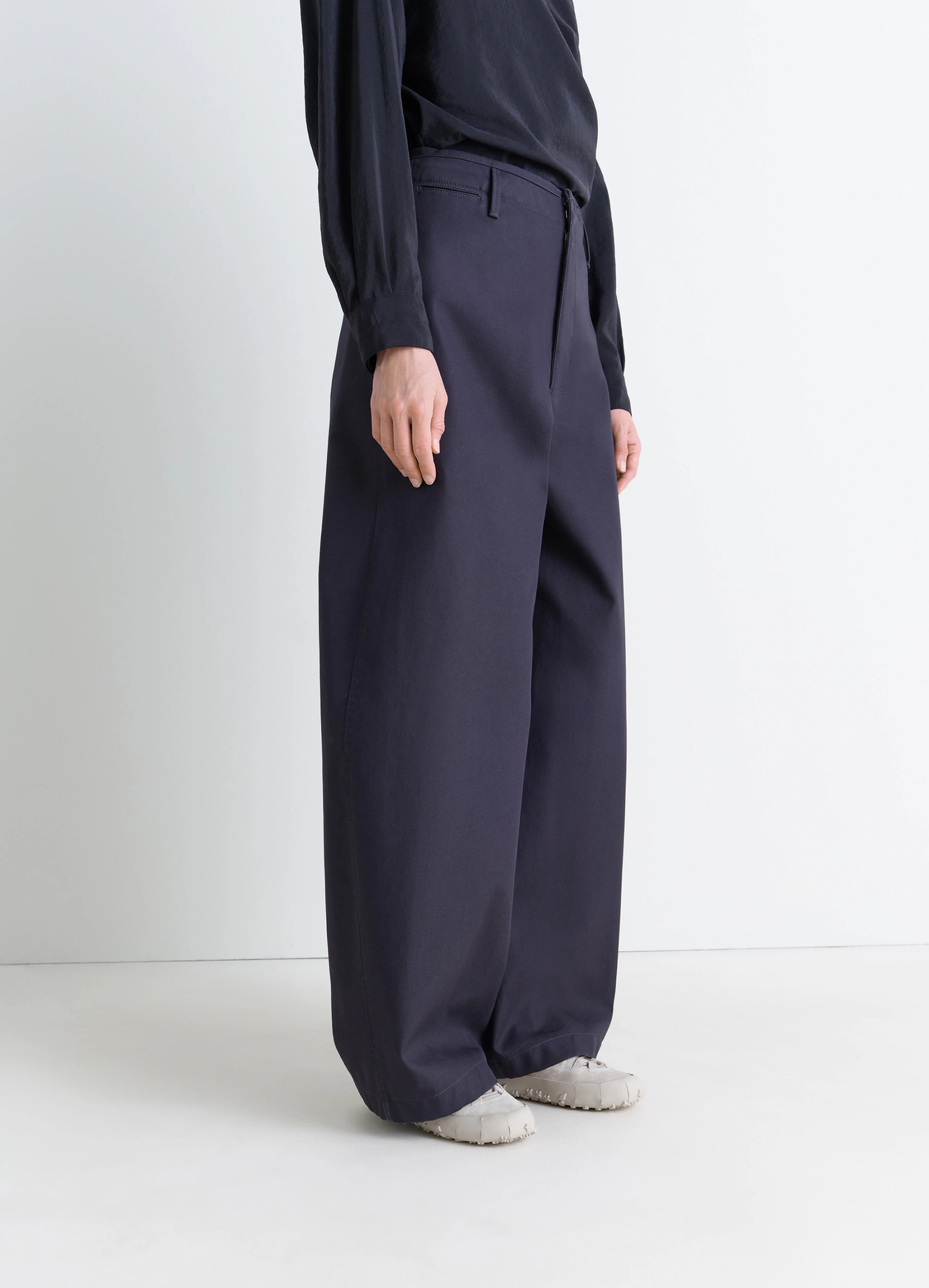 Vibram wrap on sneakers in textured hand-sueded lambskin, model shot, three-quarter view worn with wide leg pants