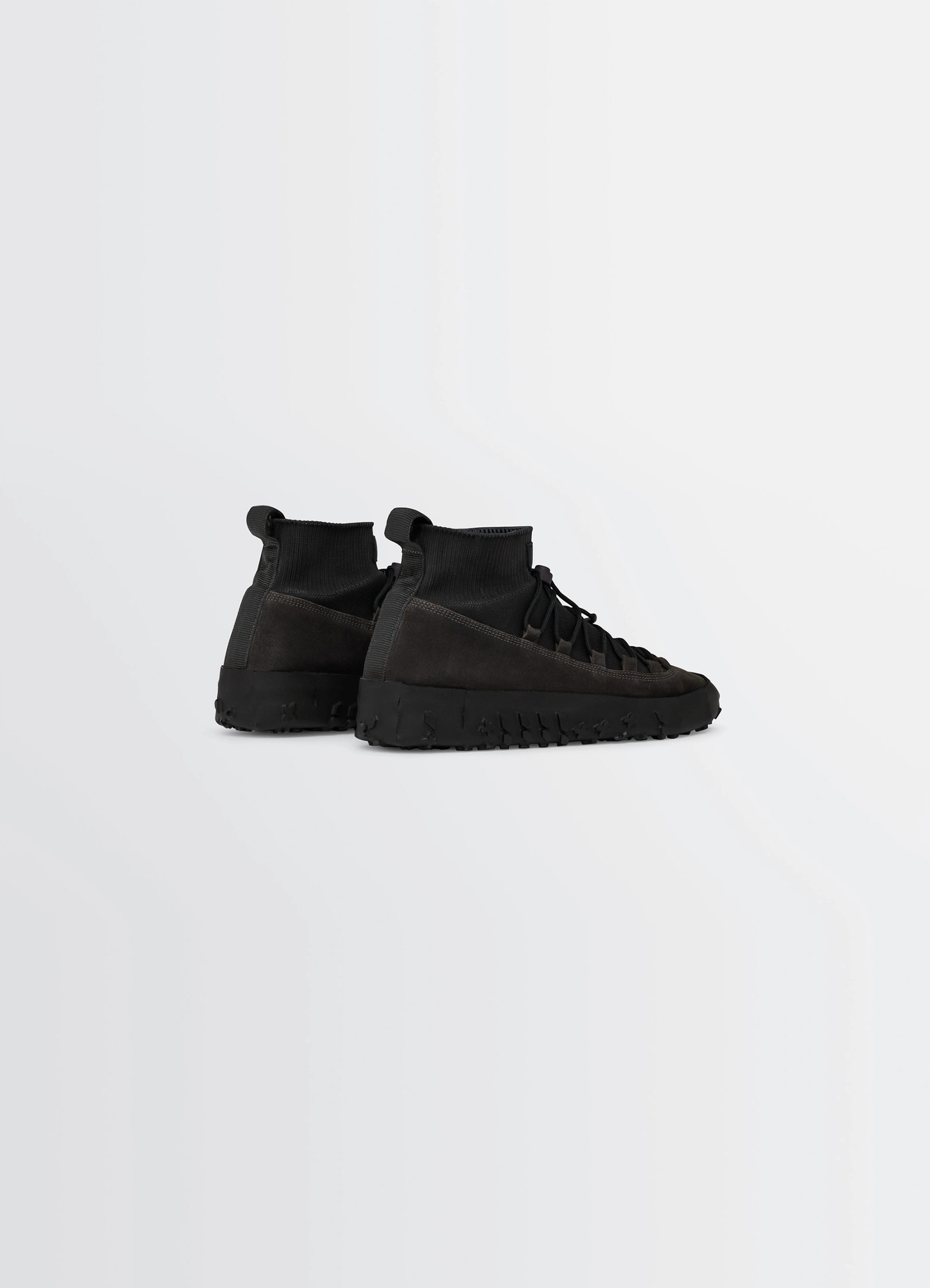 Vibram wrap on sneakers in black supple leather, product shot, rear three-quarter view textured sole, heel loop