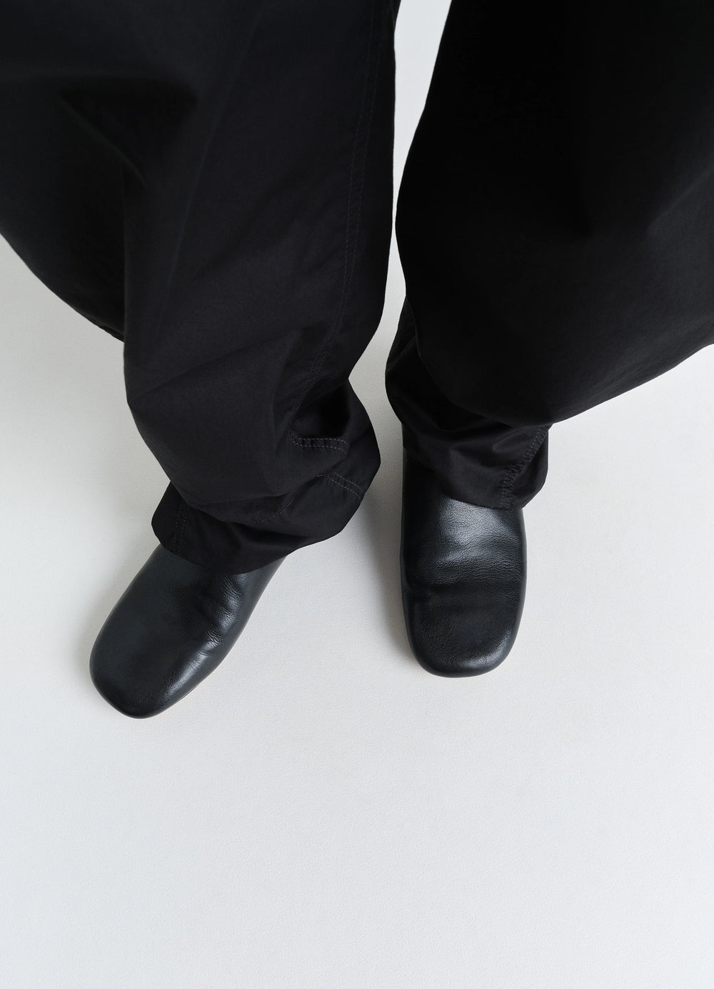 LEMAIRE Slippers in Black Shiny Buffalo Leather, model shot, top-down view square toe design