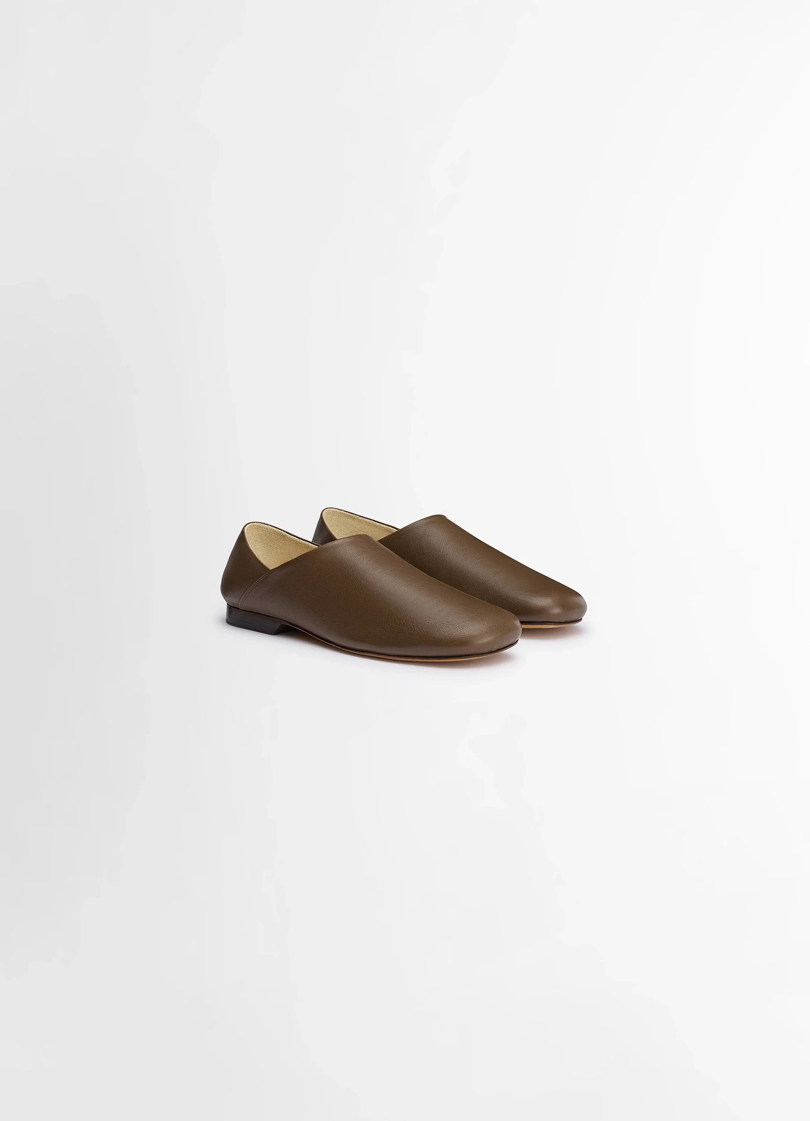 Lemaire slippers in shiny buffalo leather, product shot, angled front view soft contour profile