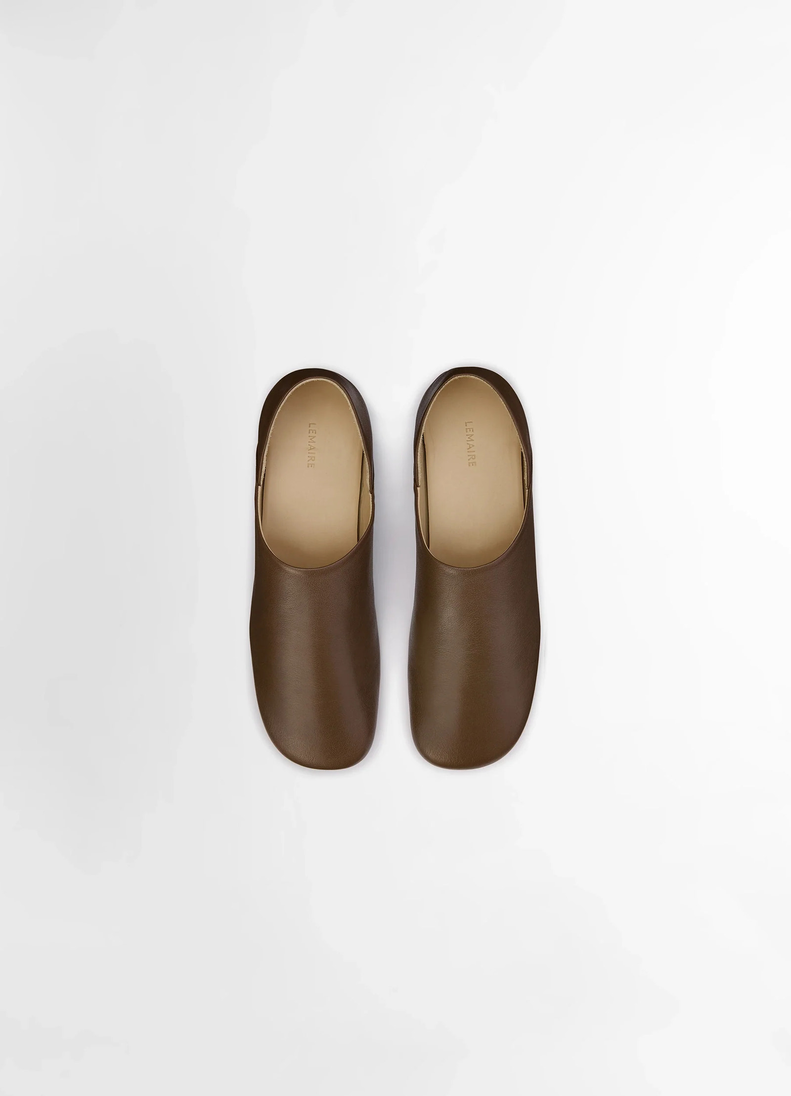 Lemaire slippers in shiny buffalo leather, product shot, aerial view rounded edge design