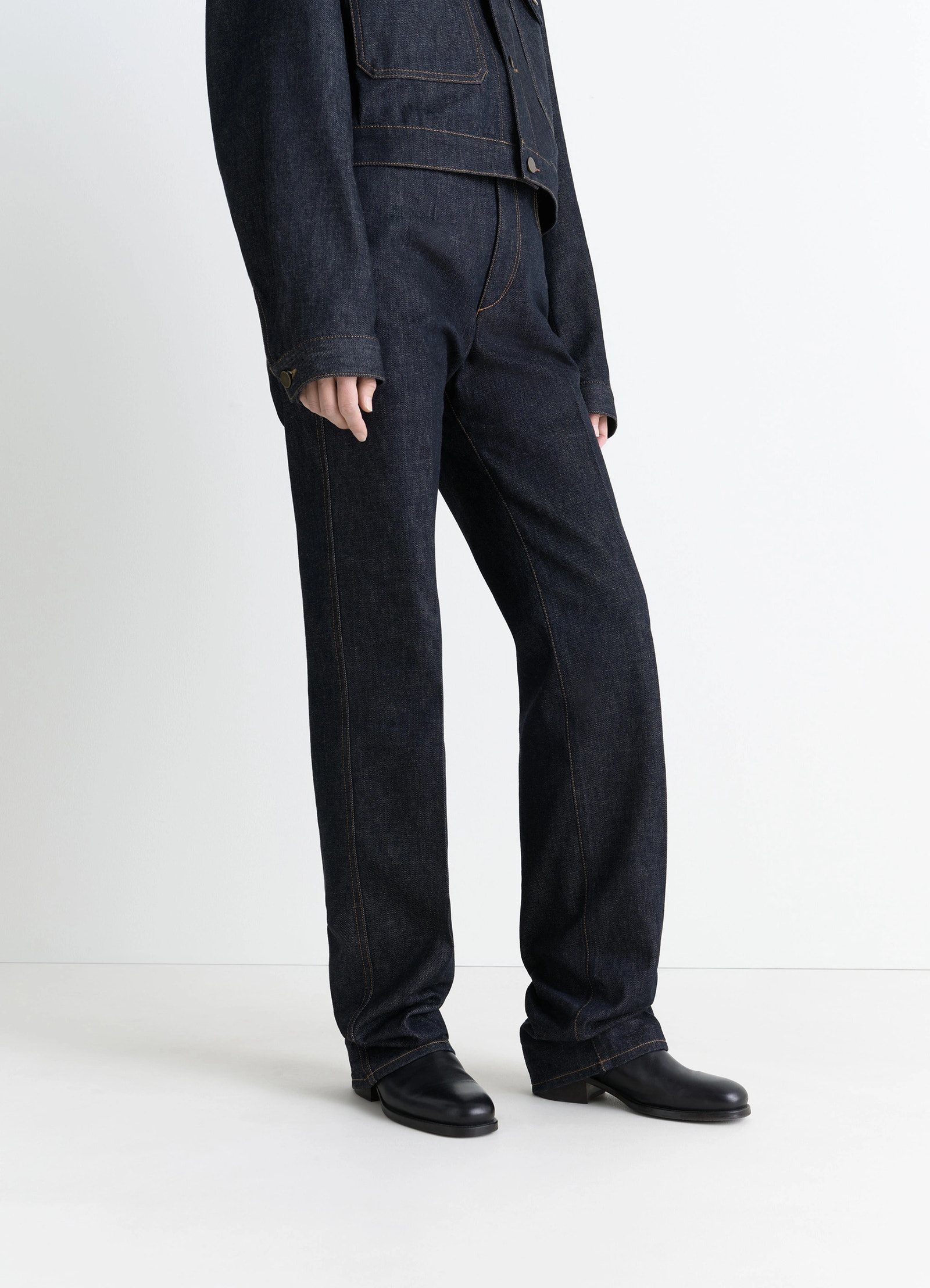 Chelsea ankle boots in black vegetable-tanned leather, model shot, three-quarter view worn with dark denim