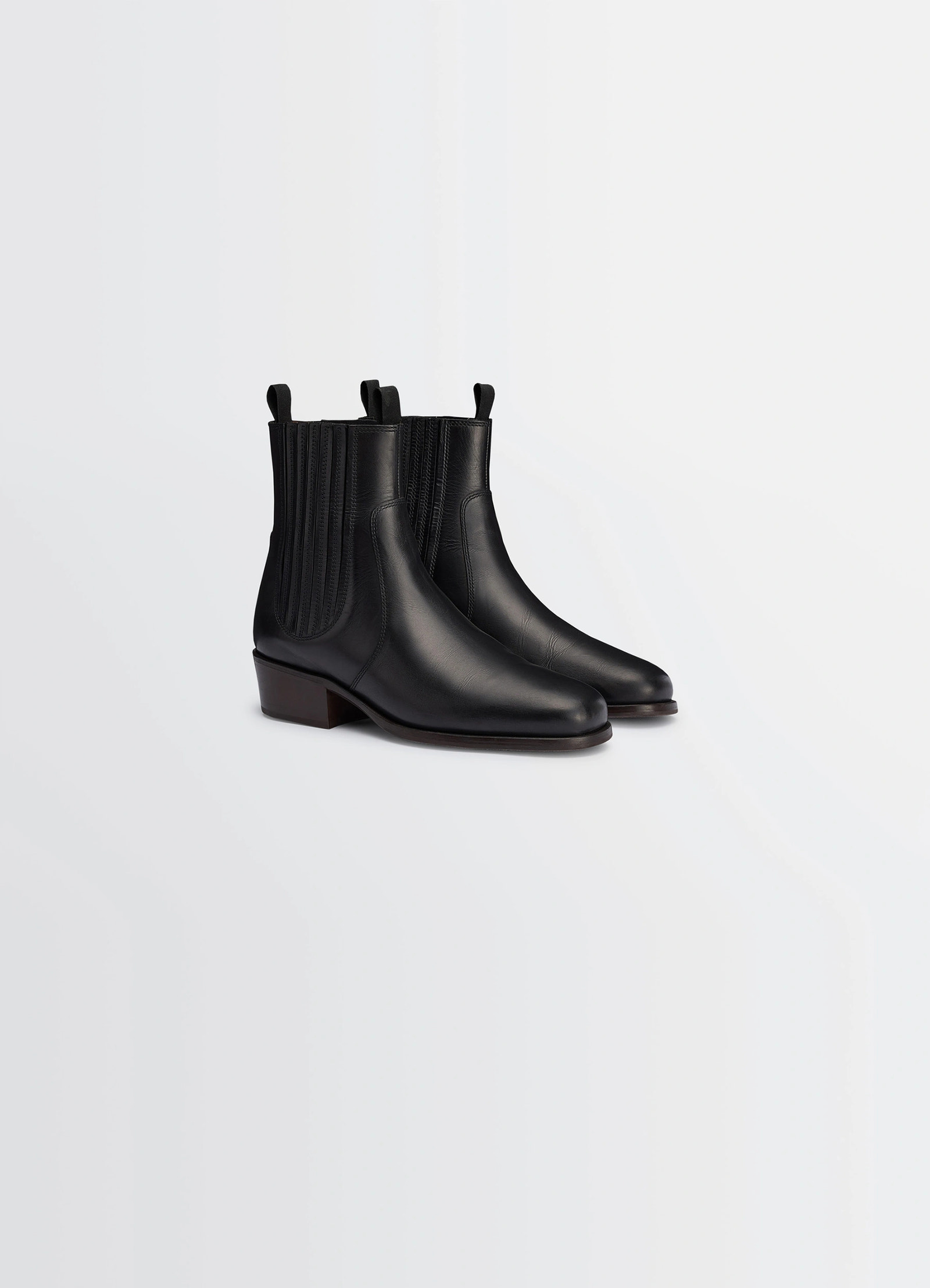 Chelsea ankle boots in black vegetable-tanned leather, product shot, angled front view square toe design