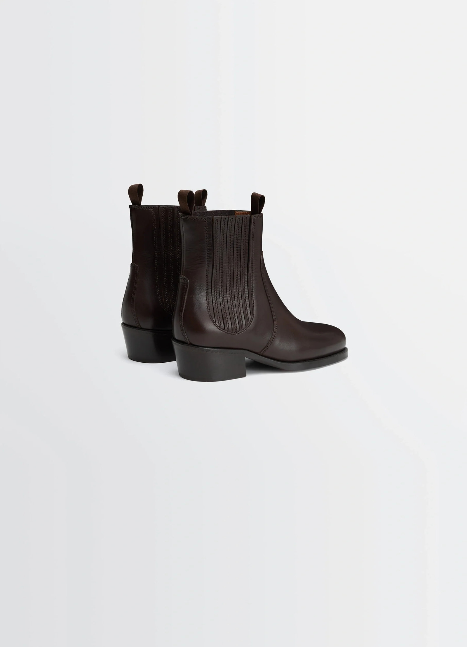 Chelsea boots in vegetable-tanned leather, product shot, back three-quarter view pull tab detail visible