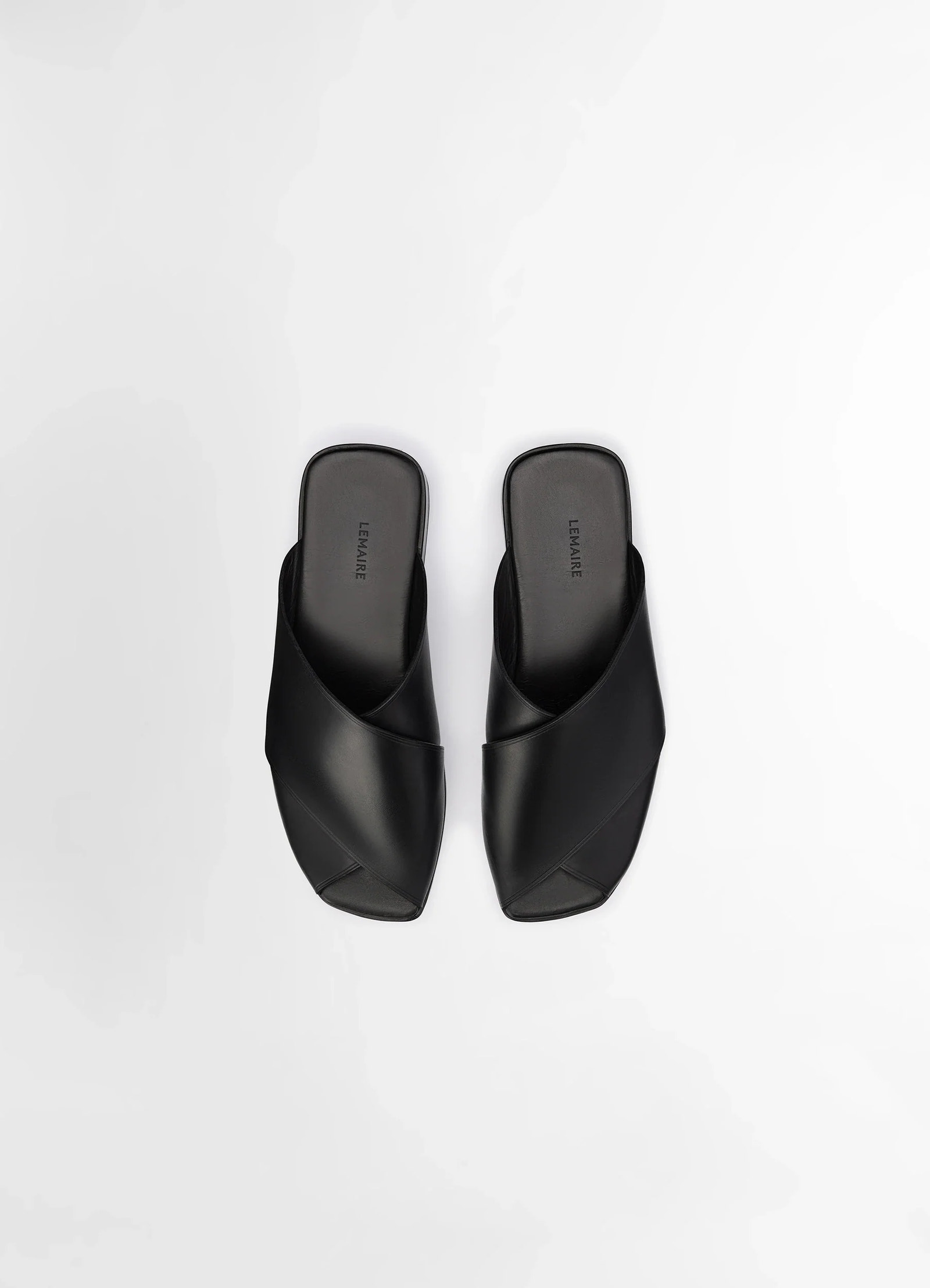 Lemaire cross flat sandals in soft shiny vegetable nappa, product shot, top down view smooth interwoven design