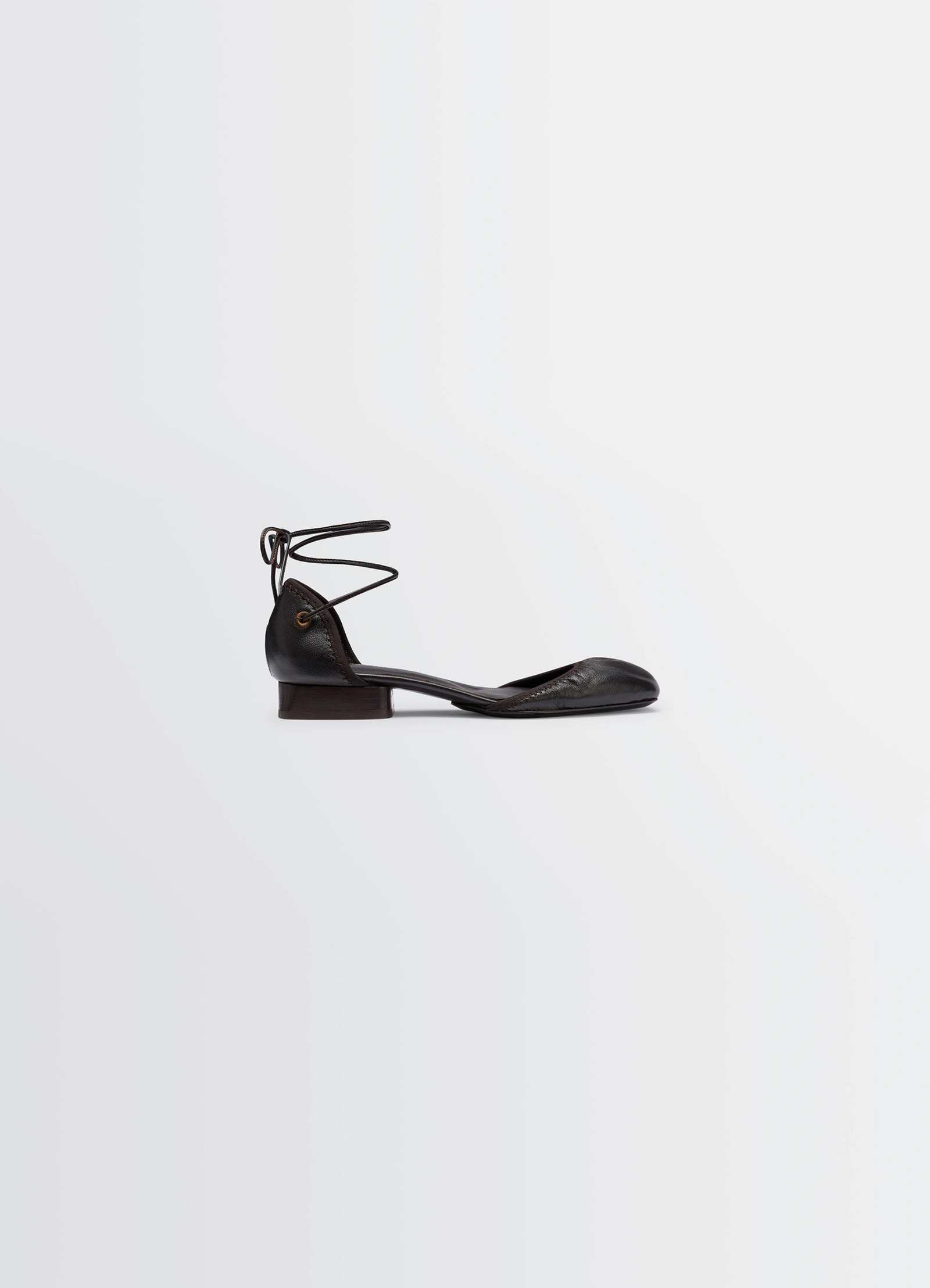 Micro ballerina flat in black supple leather, product shot, side view ankle strap detail
