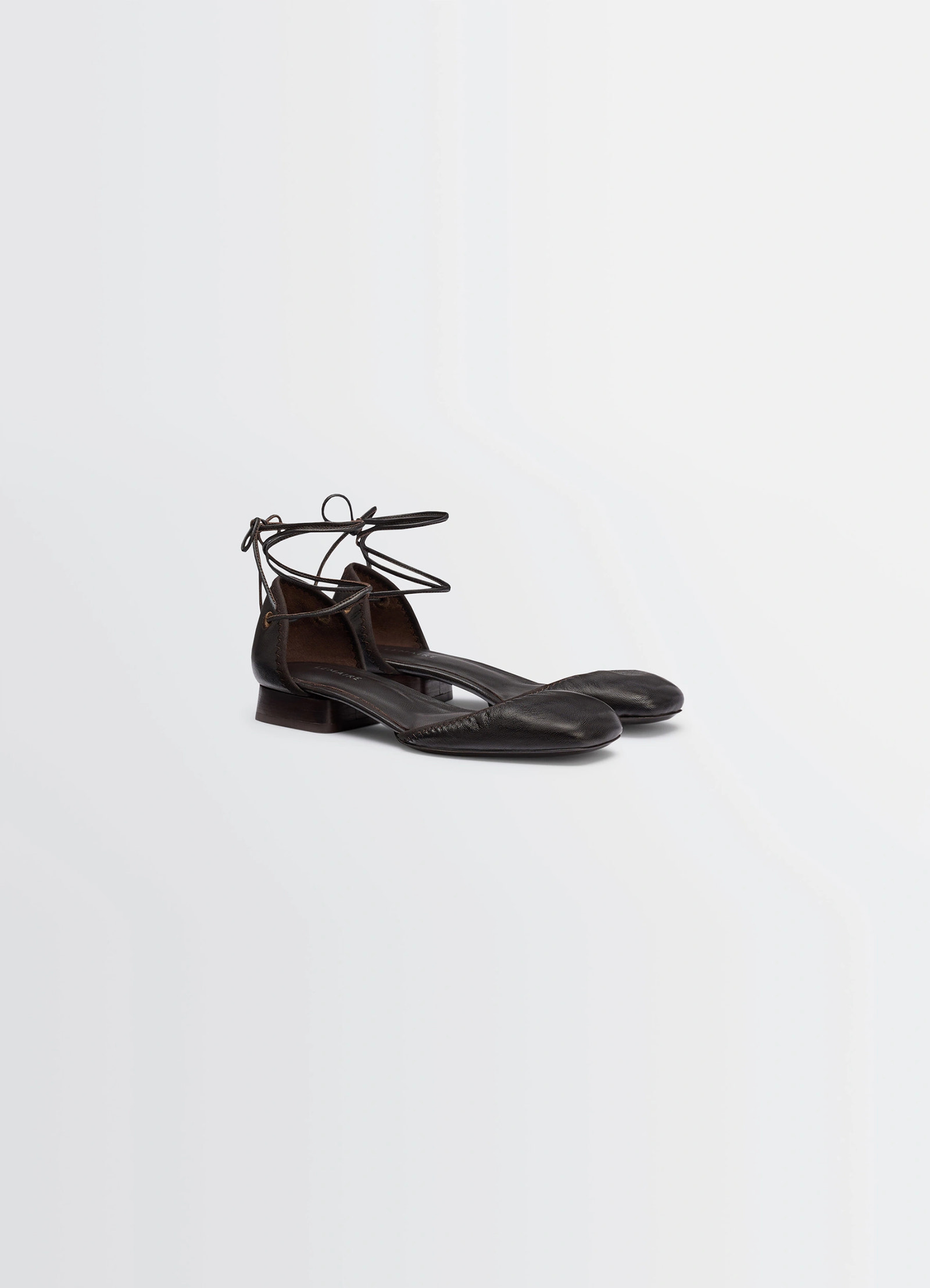 Micro ballerina flat in black supple leather, product shot, front three-quarter view smooth round toe feature
