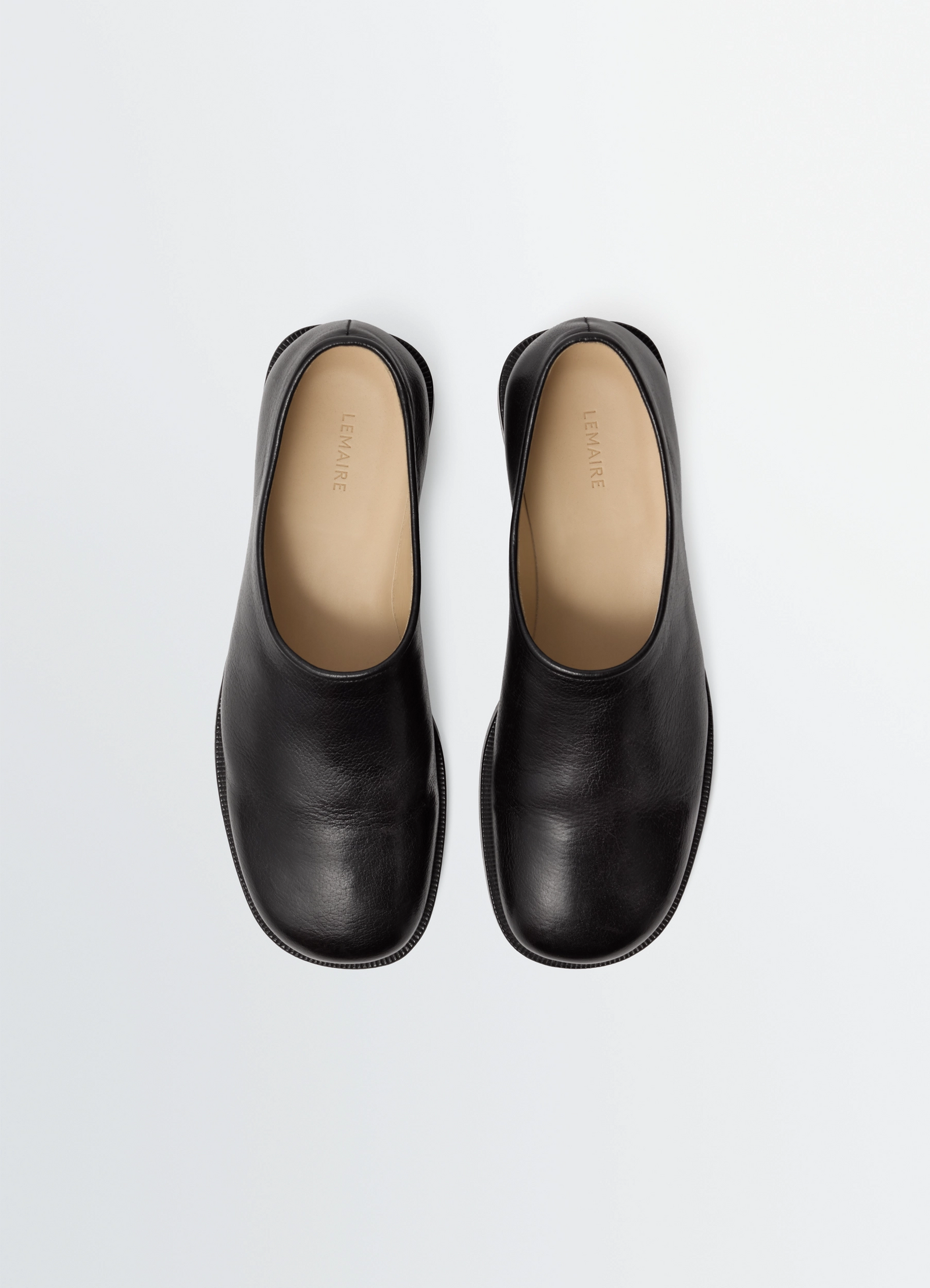 Anatomic slip on in smooth glossy black buffalo leather, product shot, top view clean minimalist design