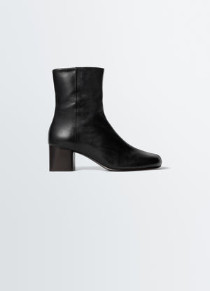 Anatomic black leather boots with 55mm block heel by lemaire side view on plain white background