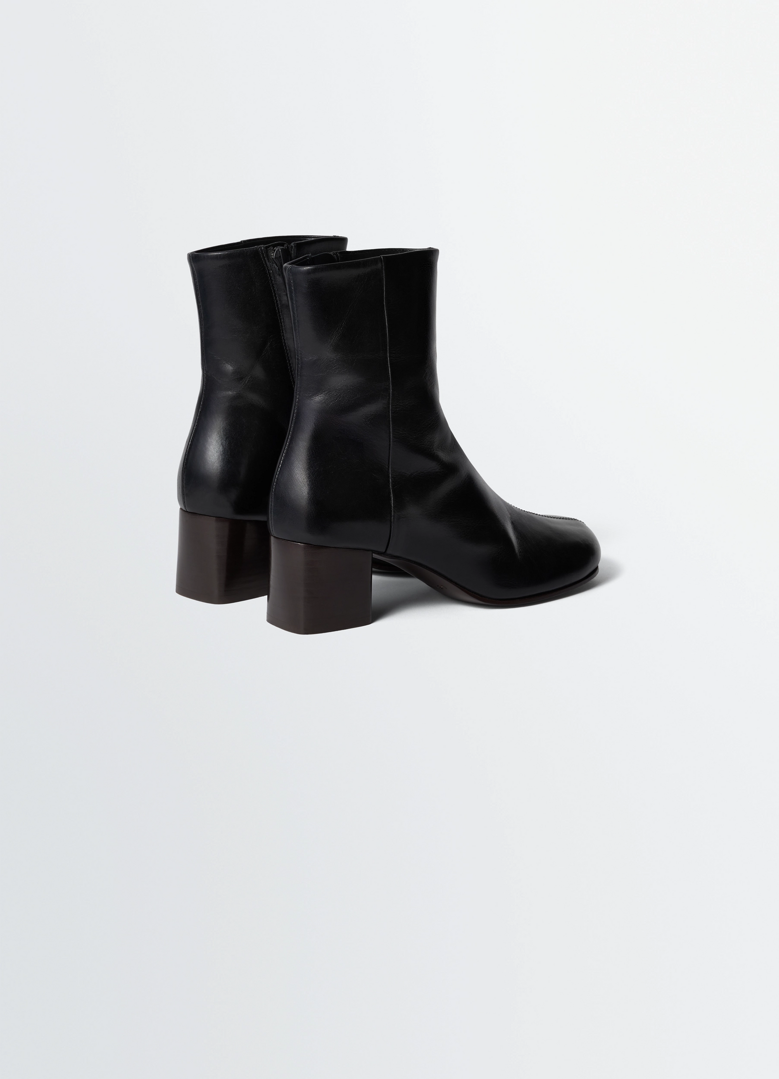 Lemaire anatomic boots in glossy vegetable-tanned leather, product shot, back three-quarter view ankle height with zipper