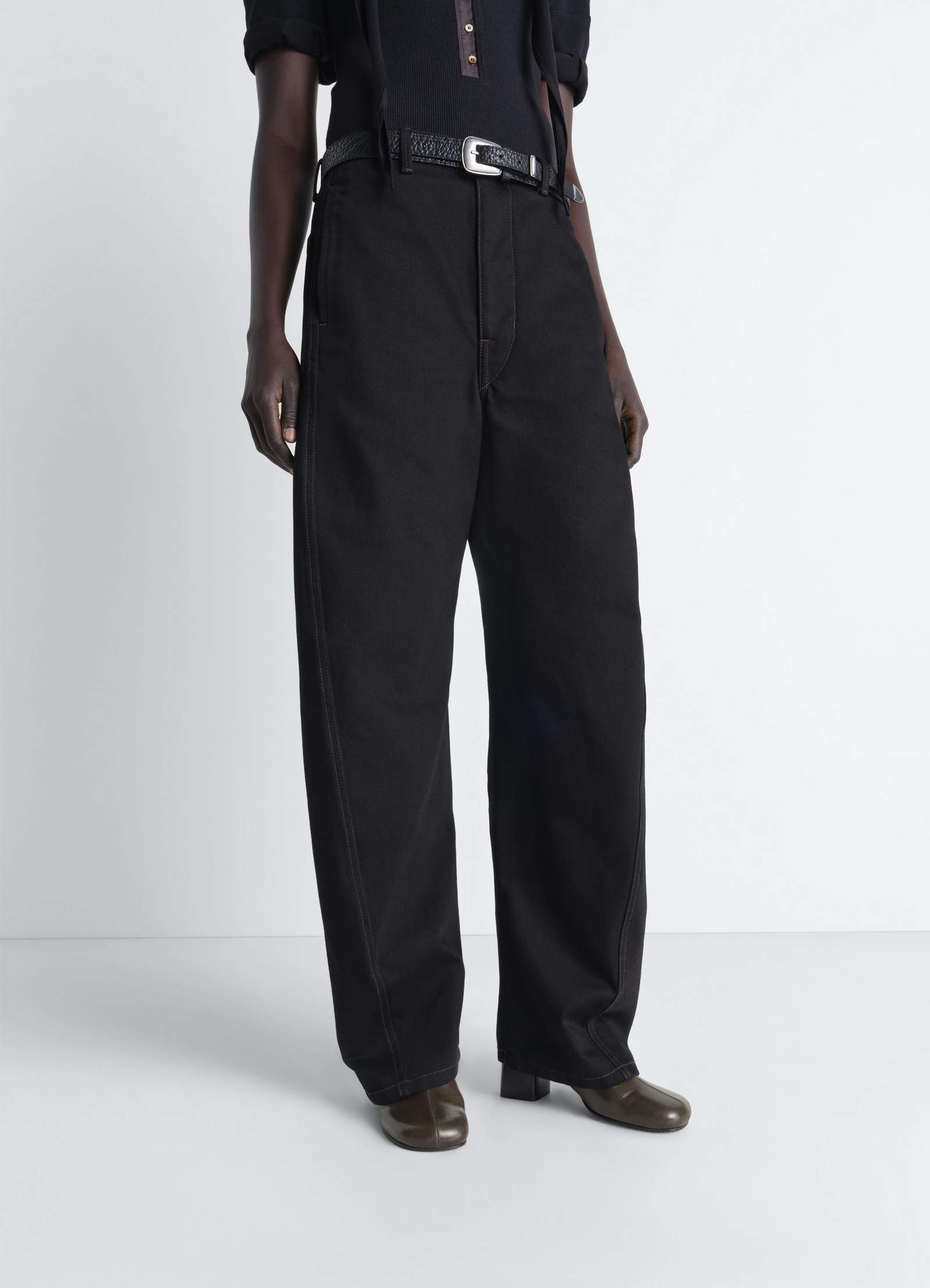 Lemaire anatomic boots in glossy vegetable-tanned leather, model shot, partial front view worn with wide leg pants