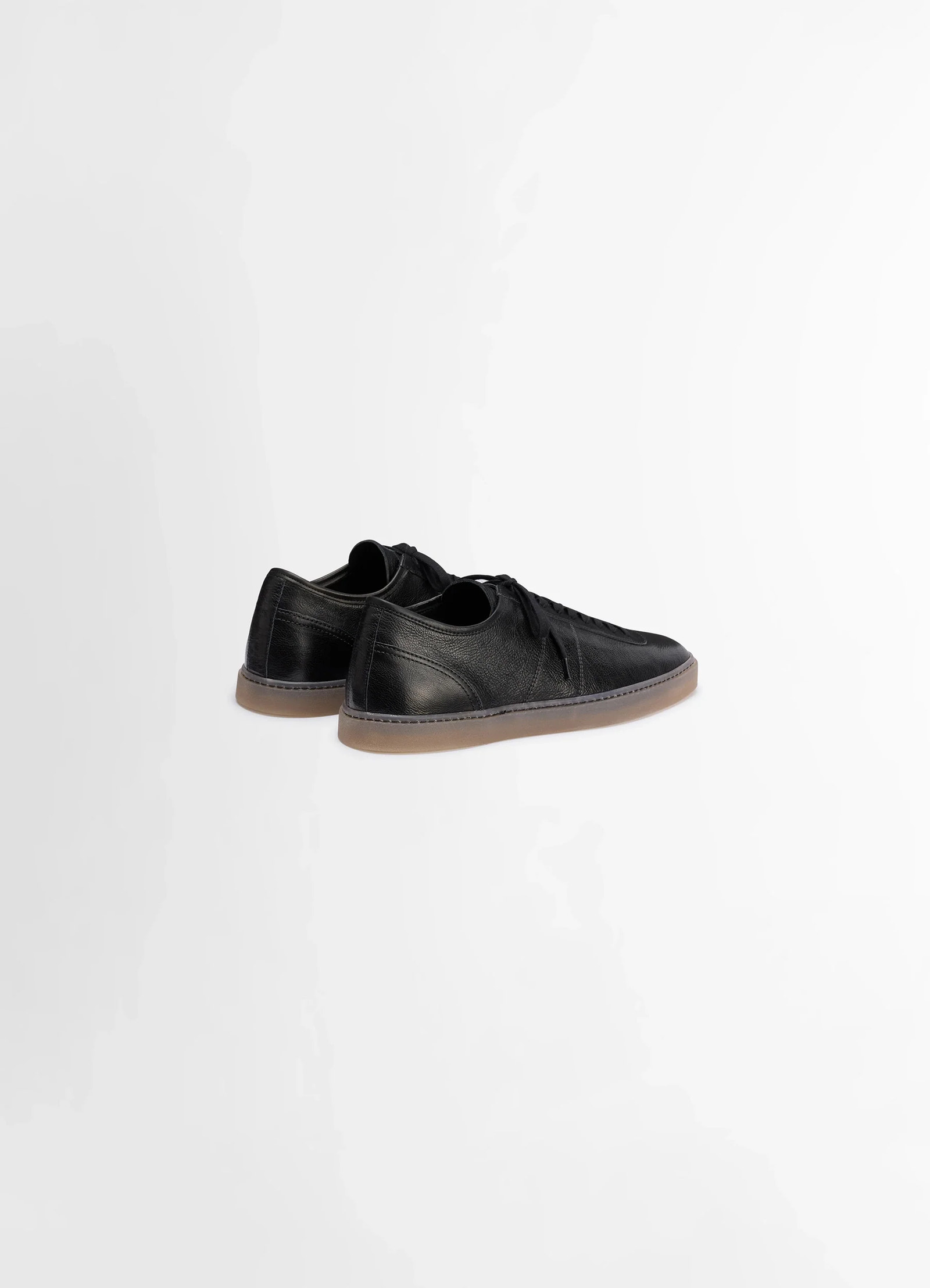 Linoleum laced up trainers in black smooth cow leather, product shot, rear angle view low profile sleek finish
