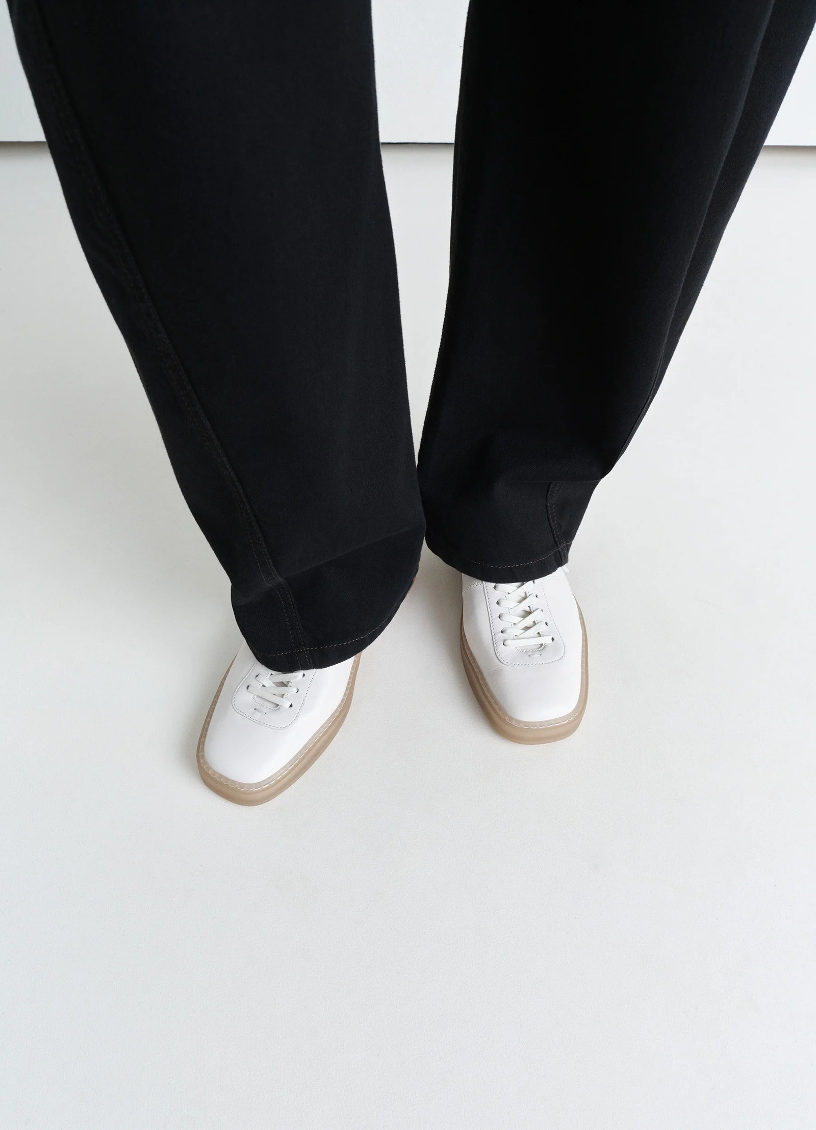 Lemaire linoleum laced up trainers in smooth soft cow leather, model shot, top down view white top with tan edges