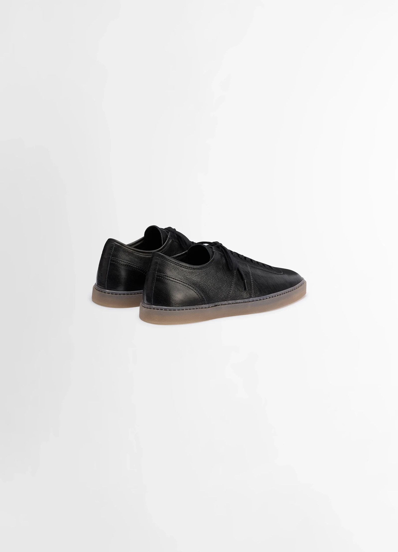 Linoleum laced up sneakers in black smooth soft cow leather, product shot, rear diagonal view low-cut heel shape
