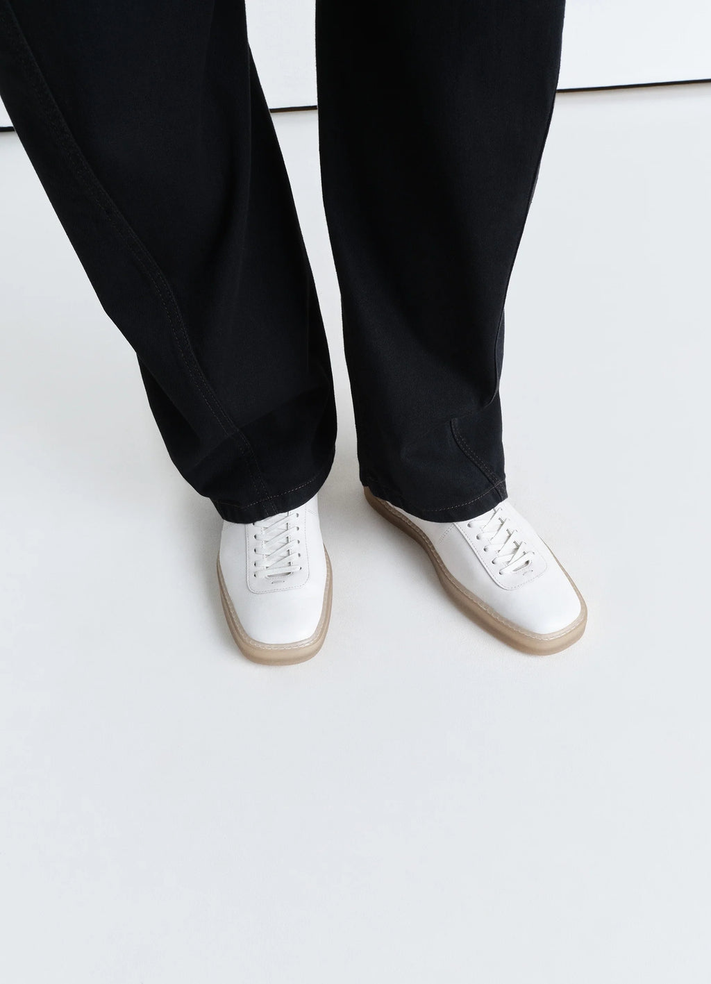 Lemaire Linoleum Laced Up Sneakers in Smooth soft cow leather, model shot, top view worn with wide leg pants
