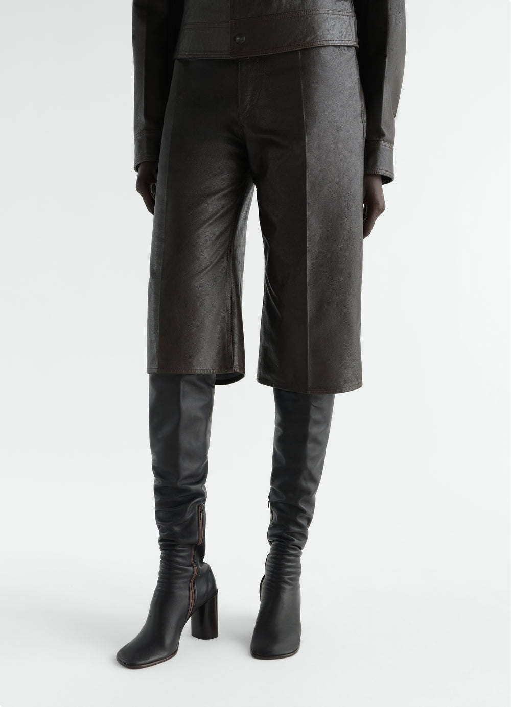 Glove High Boots 80 black leather boots worn by a model front view LEMAIRE