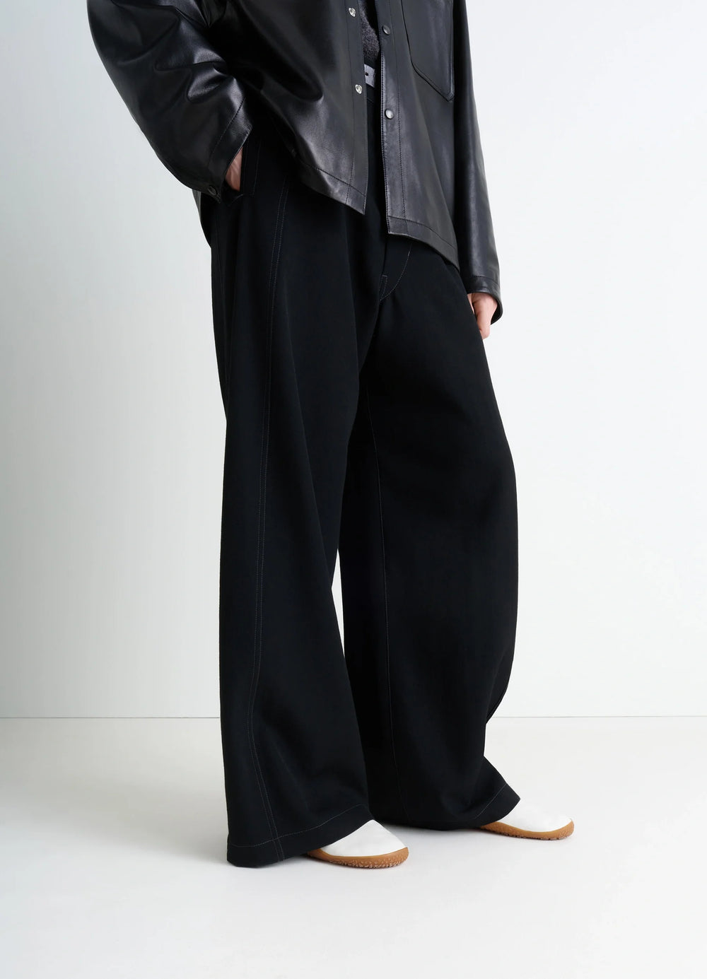 Vibram Glove Slip On in LWG Gold-certified nappa lamb leath, model shot, low angle front view covered by wide leg pants