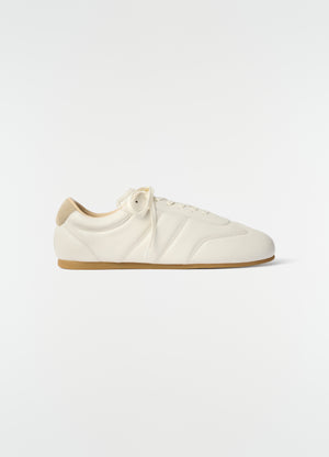 Soft white leather sneaker with gum sole and beige suede heel patch lemaire side view on white background