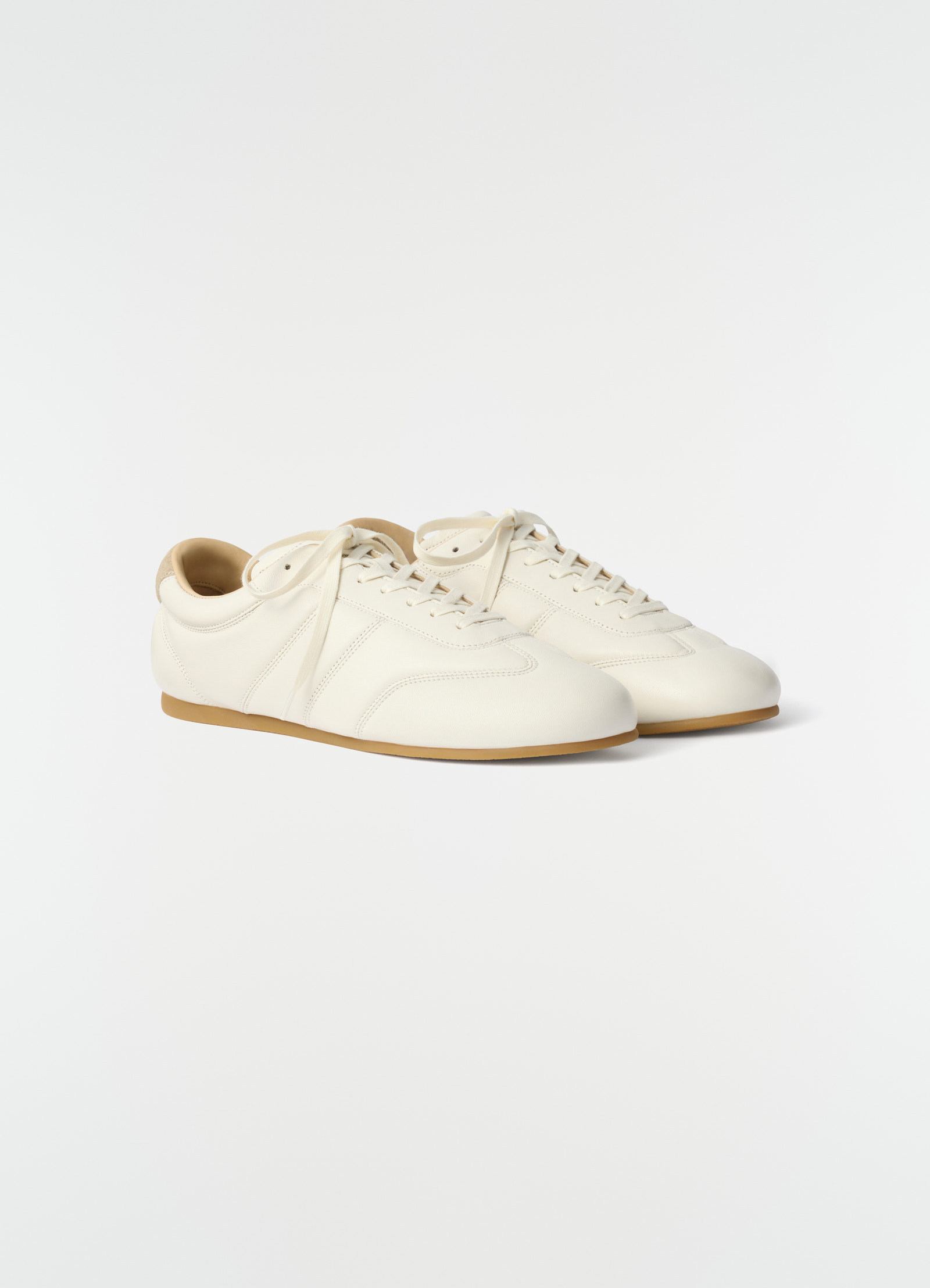 Soft runner sneakers in off-white leather with gum sole by lemaire side view on plain background