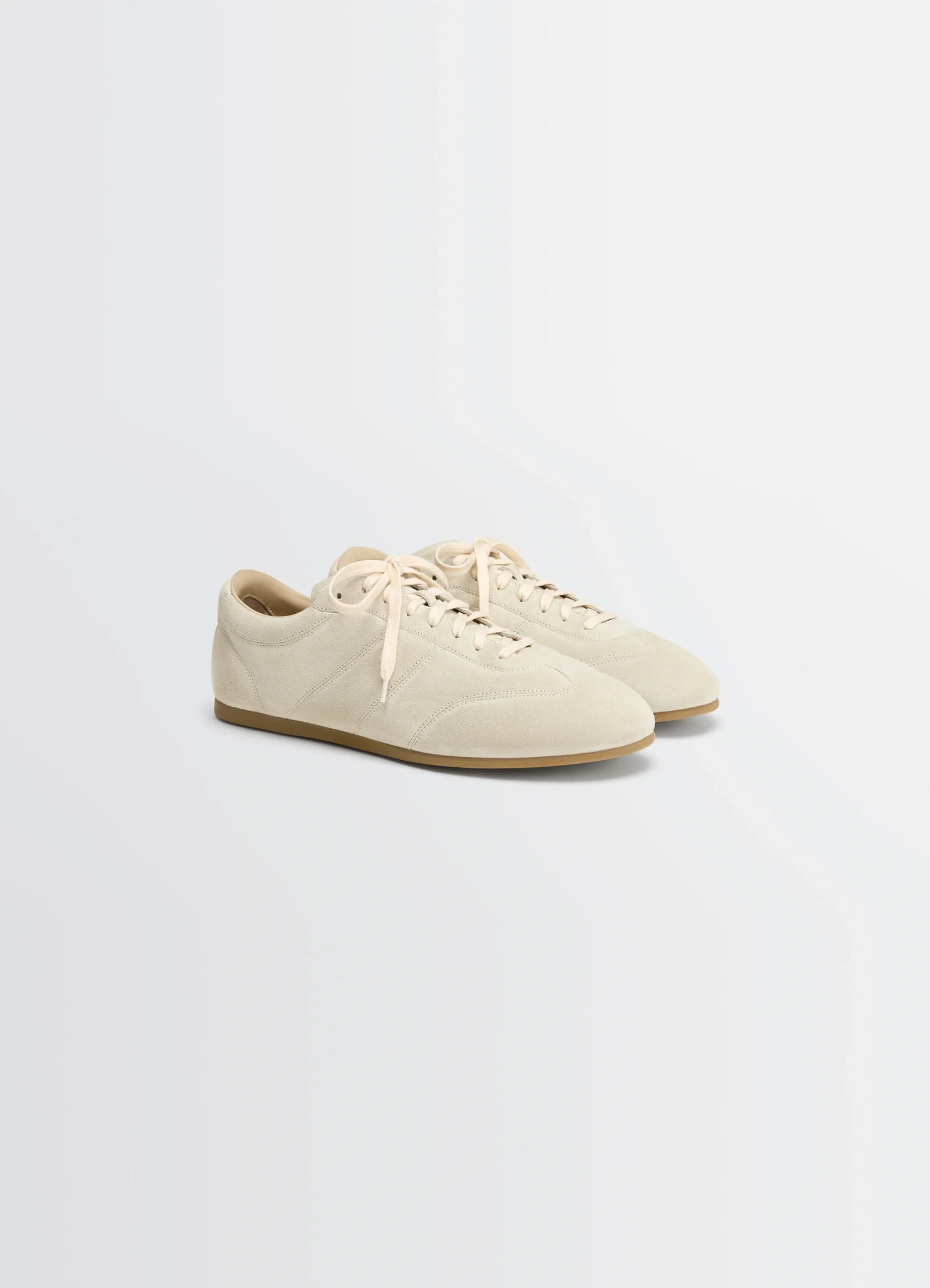 Soft runner in cream hand-sueded lambskin, product shot, three-quarter view low-top lace-up design