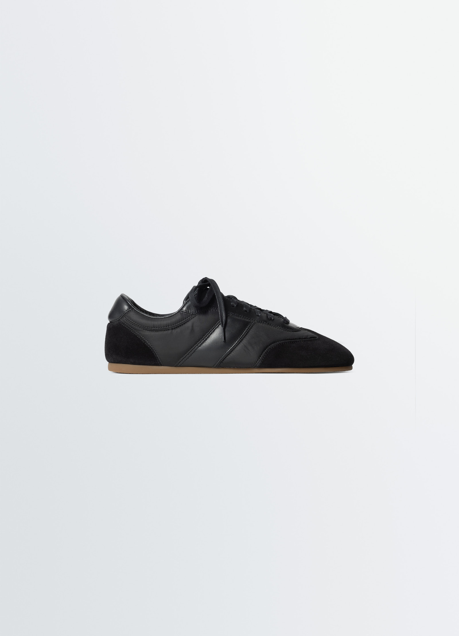 Soft runners in black suede leather, product shot, side view quilted topstitching