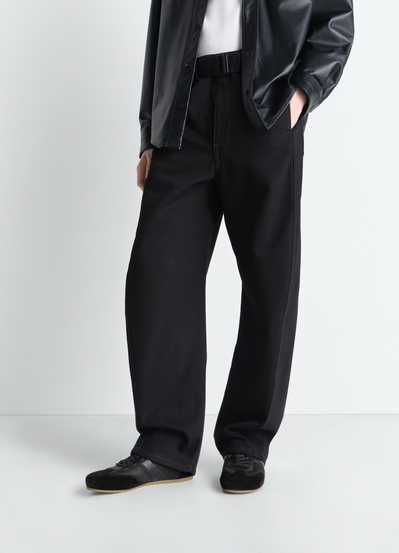 Soft runners in black suede leather, model shot, bottom front view worn with outfit