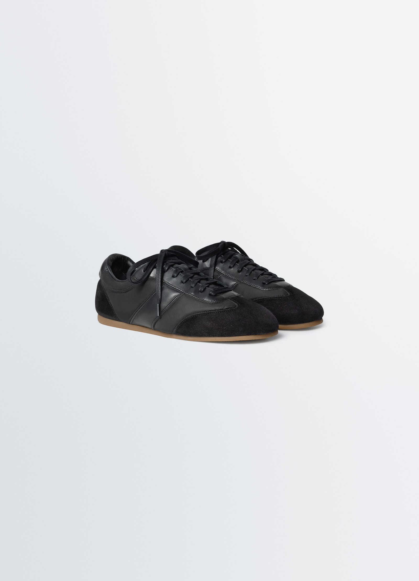 Soft runners in black suede leather, product shot, angled top view lace-up design