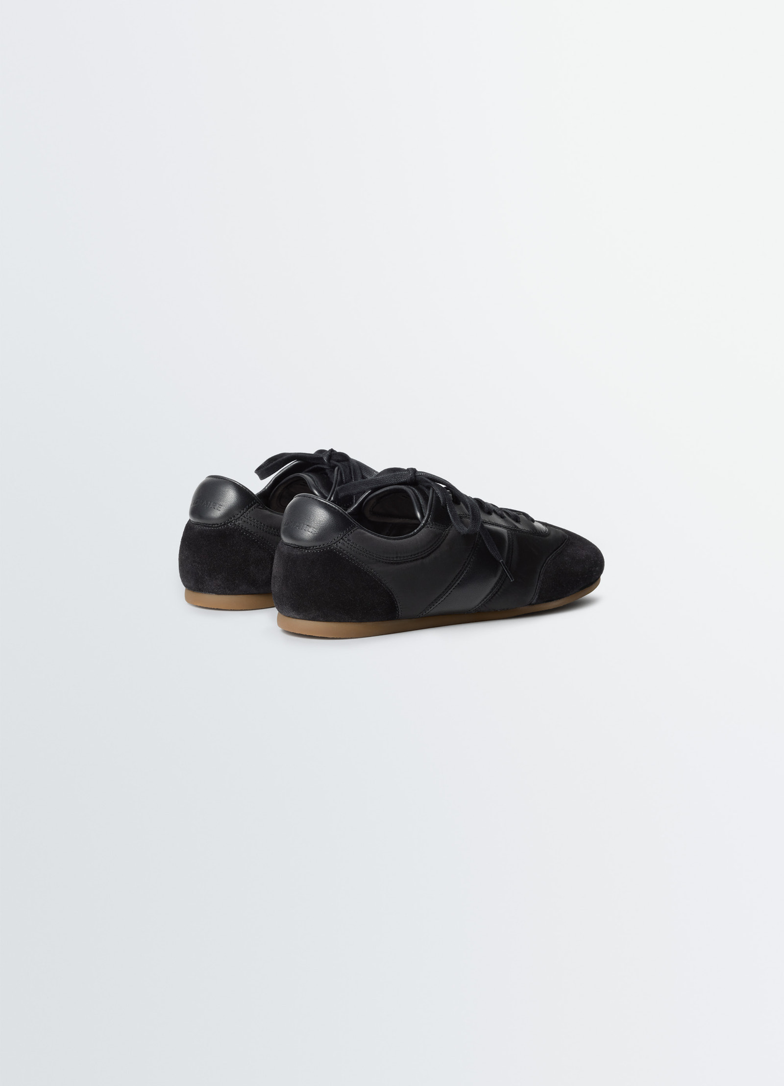 Soft runners in black suede leather, product shot, rear angled view rounded heel counter