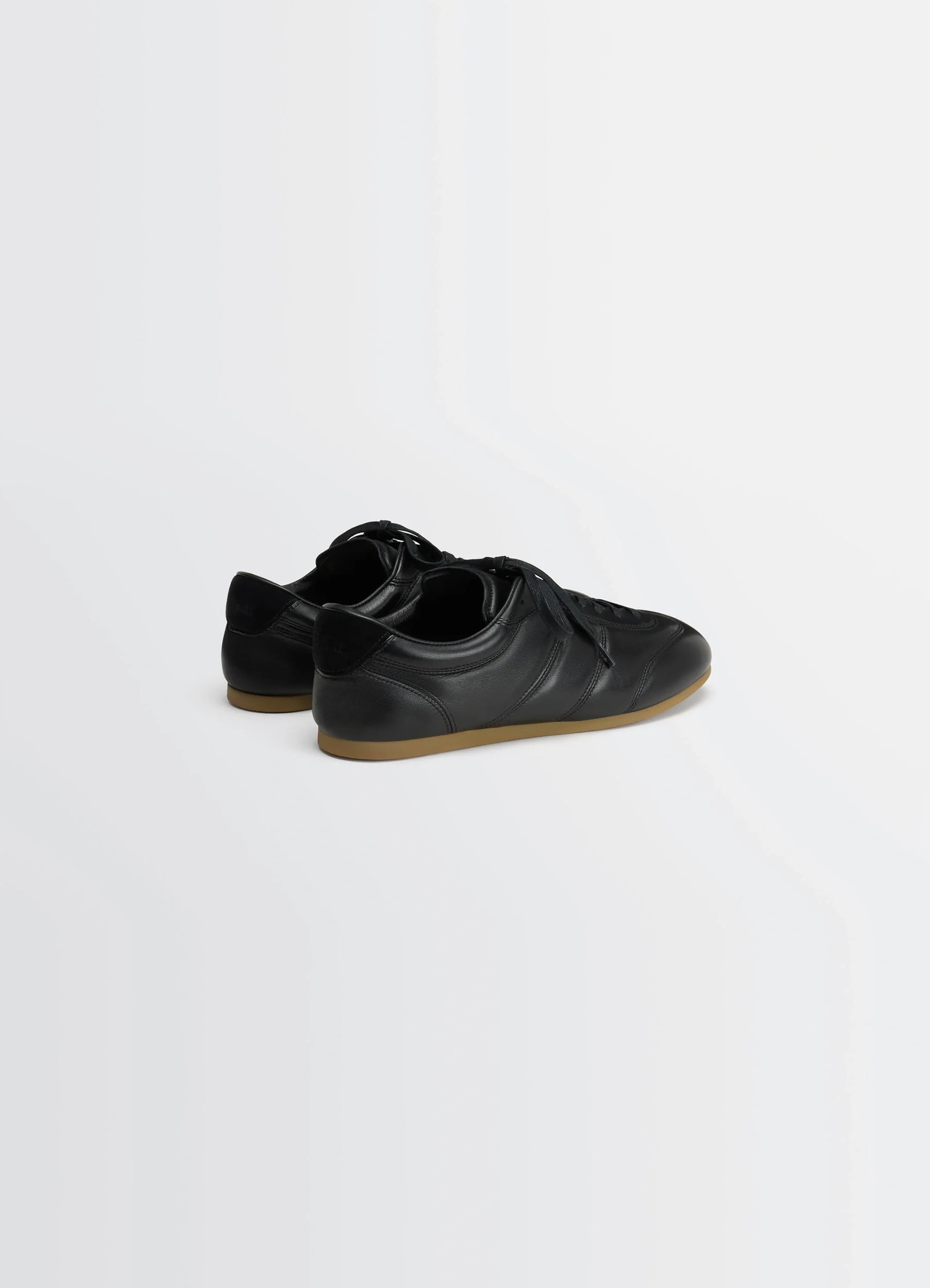Soft runner in black lwg gold-certified nappa lamb, product shot, rear three-quarter view smooth leather texture