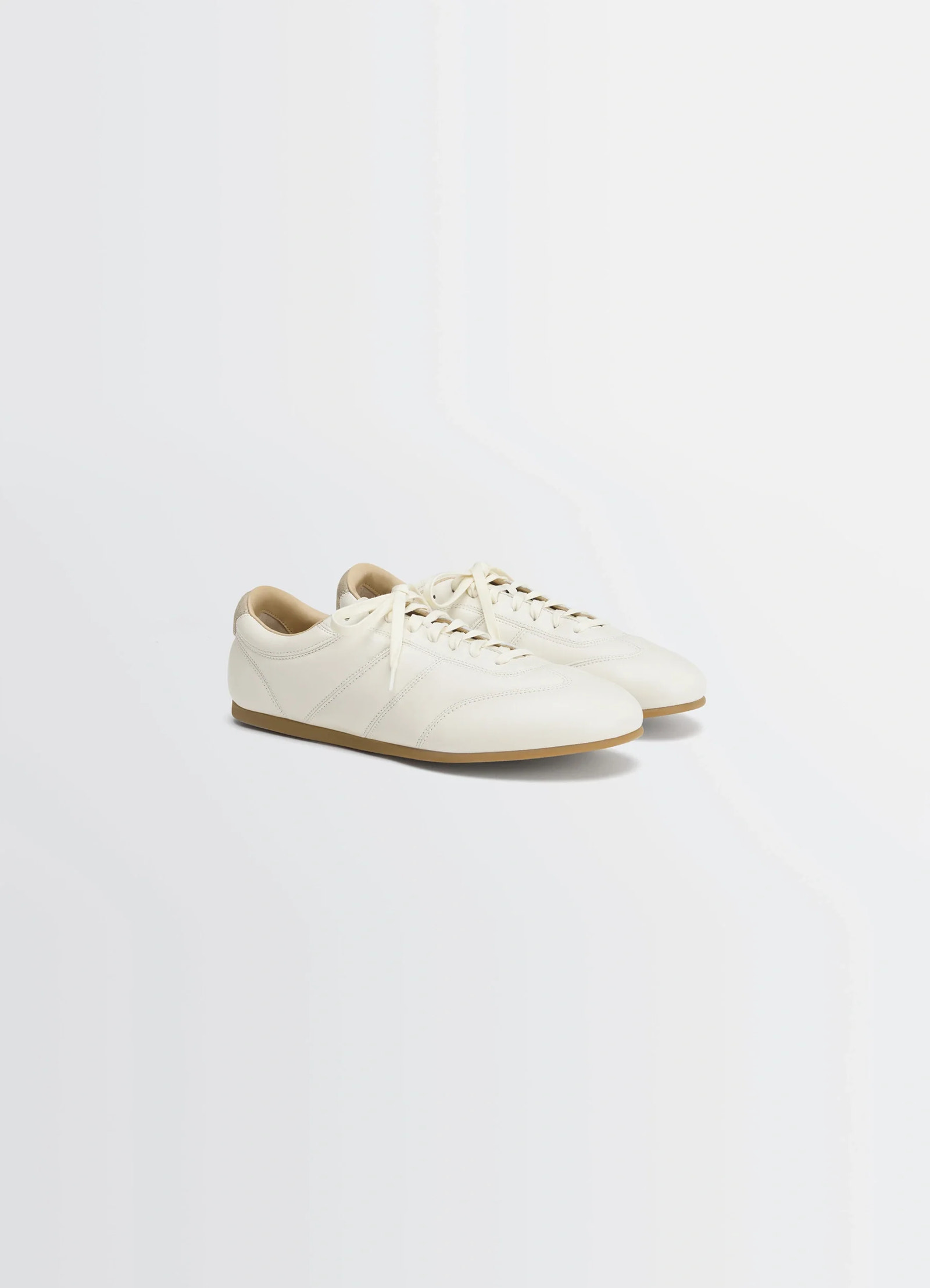 Soft runner sneakers in lwg gold nappa lamb leather, product shot, three-quarter view sleek profile design
