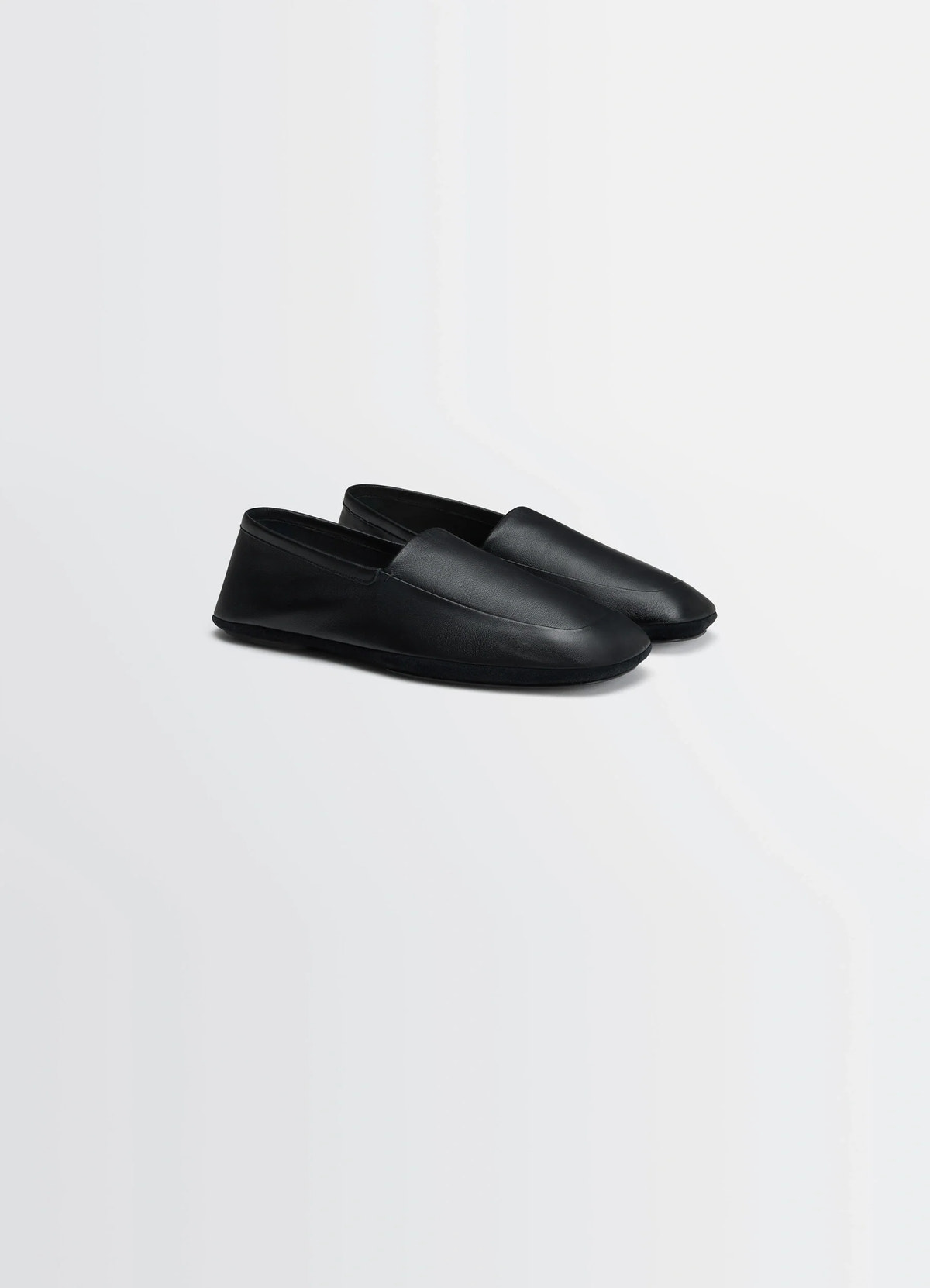 Indoor slippers in black nappa lamb leather, product shot, angled top view minimalist smooth leather