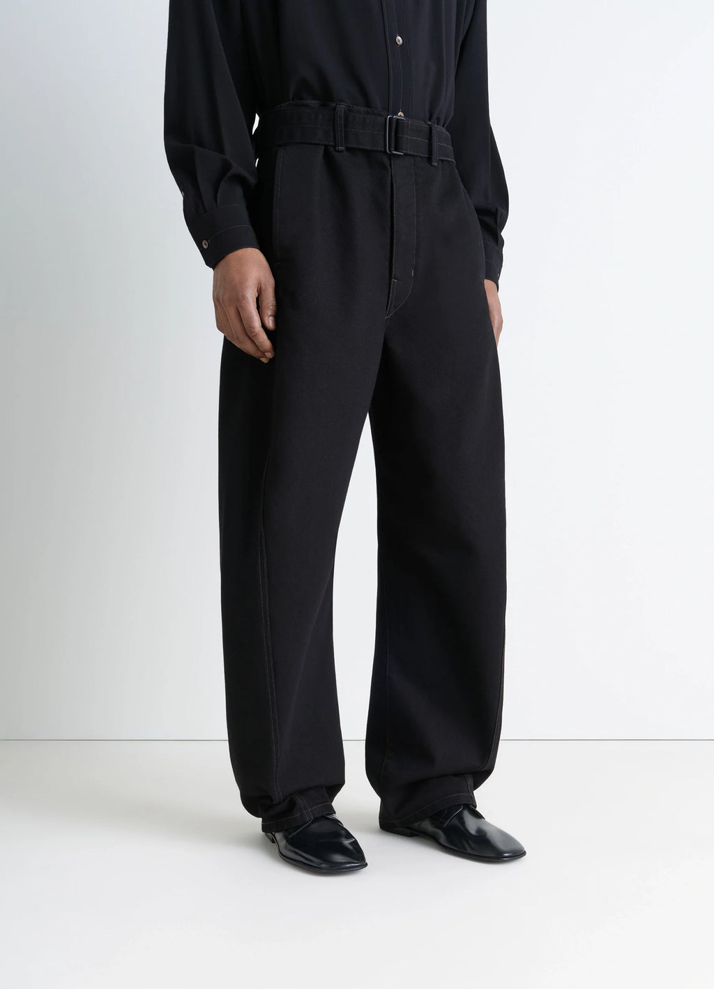 Lemaire Dance Derbies in Black Calf Leather, model shot, porte front view worn with black pants