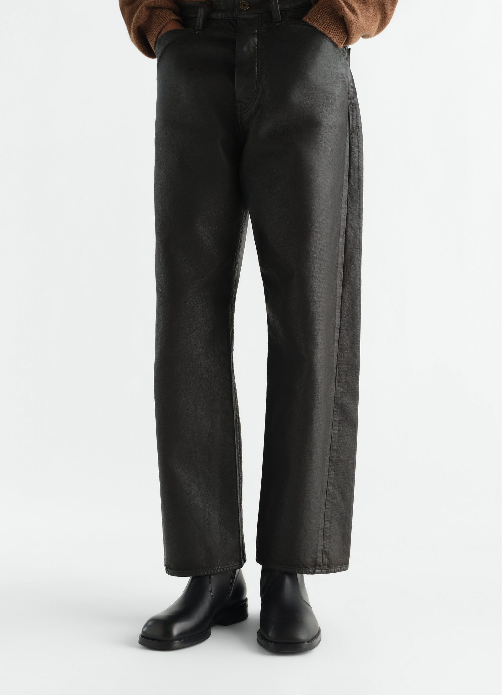 Zipped ankle boots in shiny black leather worn by a model front view lemaire