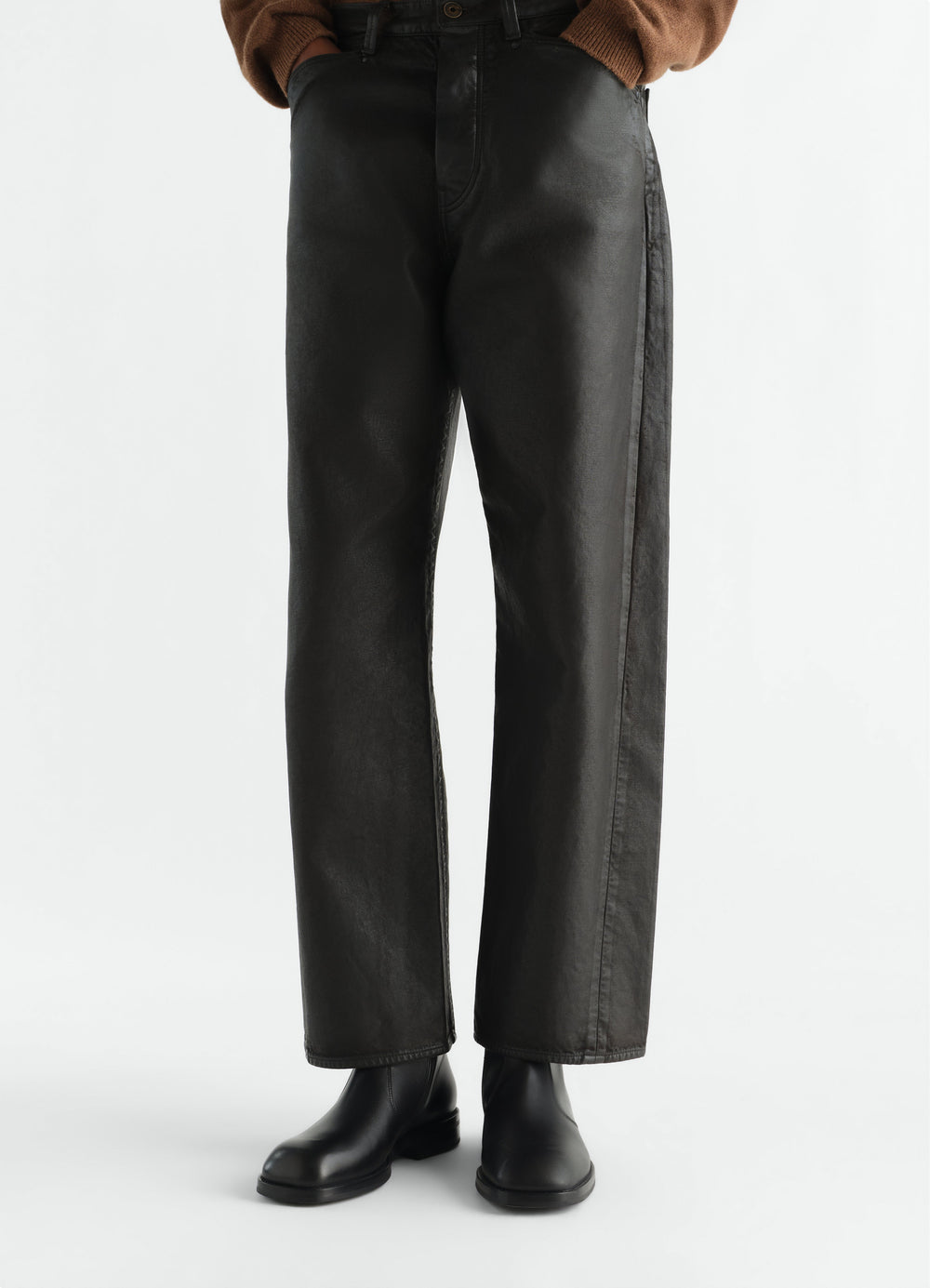 Zipped ankle boots in shiny black leather worn by a model front view LEMAIRE