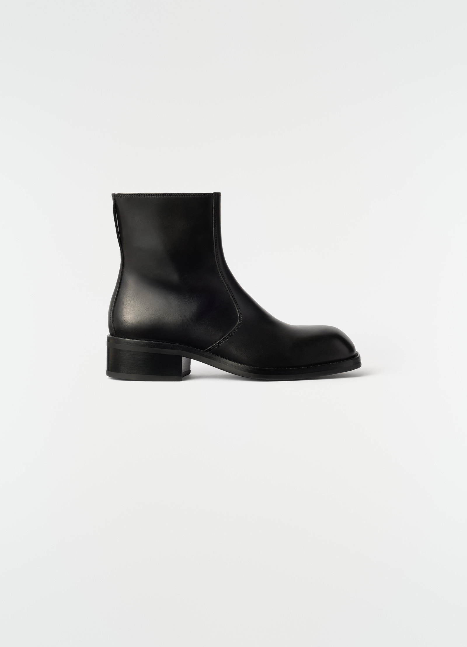 Zipped ankle boots in shiny black leather by lemaire side view on plain white background