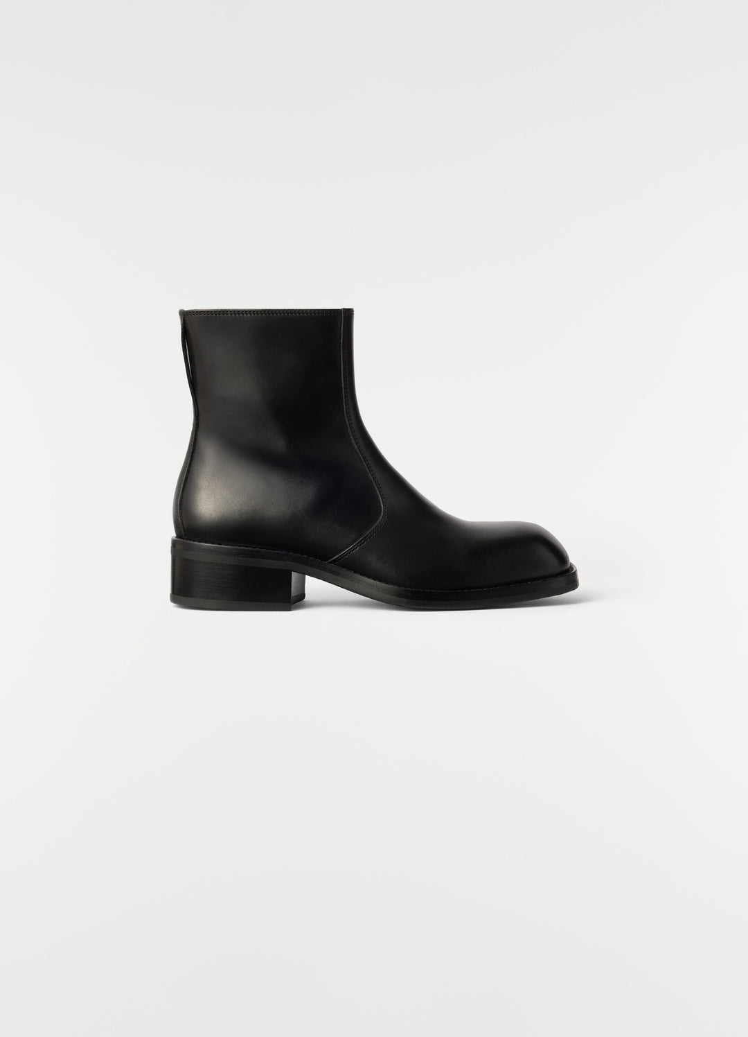 Zipped ankle boots in shiny black leather by LEMAIRE side view on plain white background