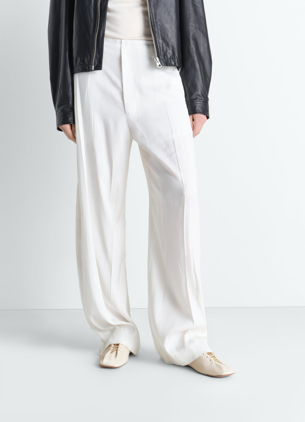 Souris flat classic leather derbies in beige by LEMAIRE worn by model front view with white pants and black jacket