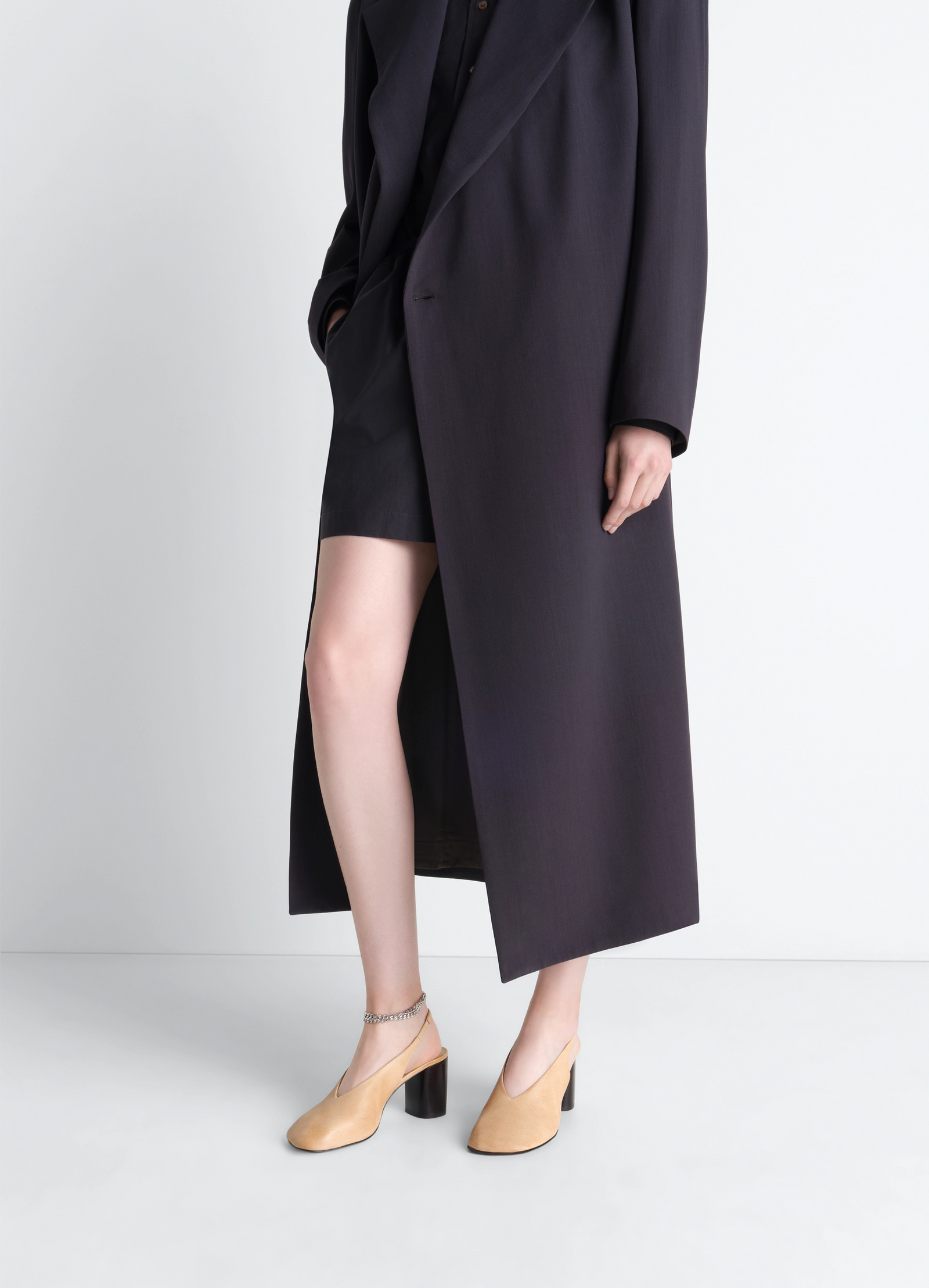 Glove slingback pumps 80 mm heel in washed buffalo leather, model shot, front angled view worn with coat