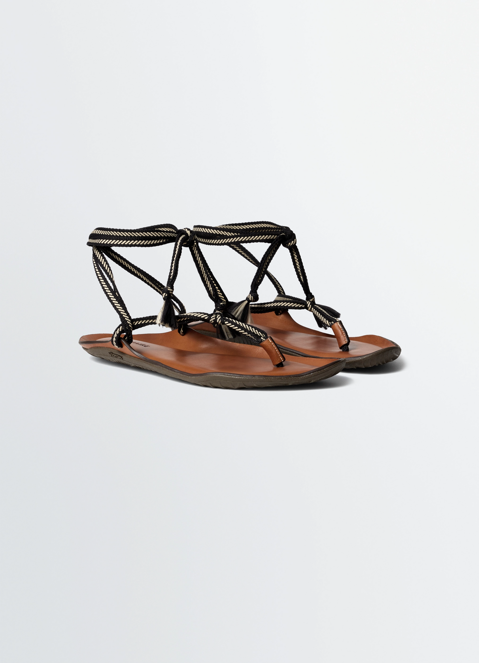 Vibram sandals in leather, product shot, angled front view crisscross rope straps