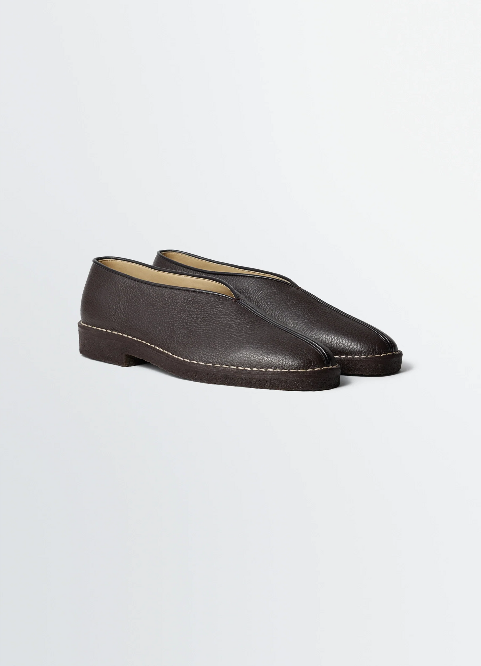 Lemaire piped crepe slippers in leather, product shot, three-quarter view grained texture