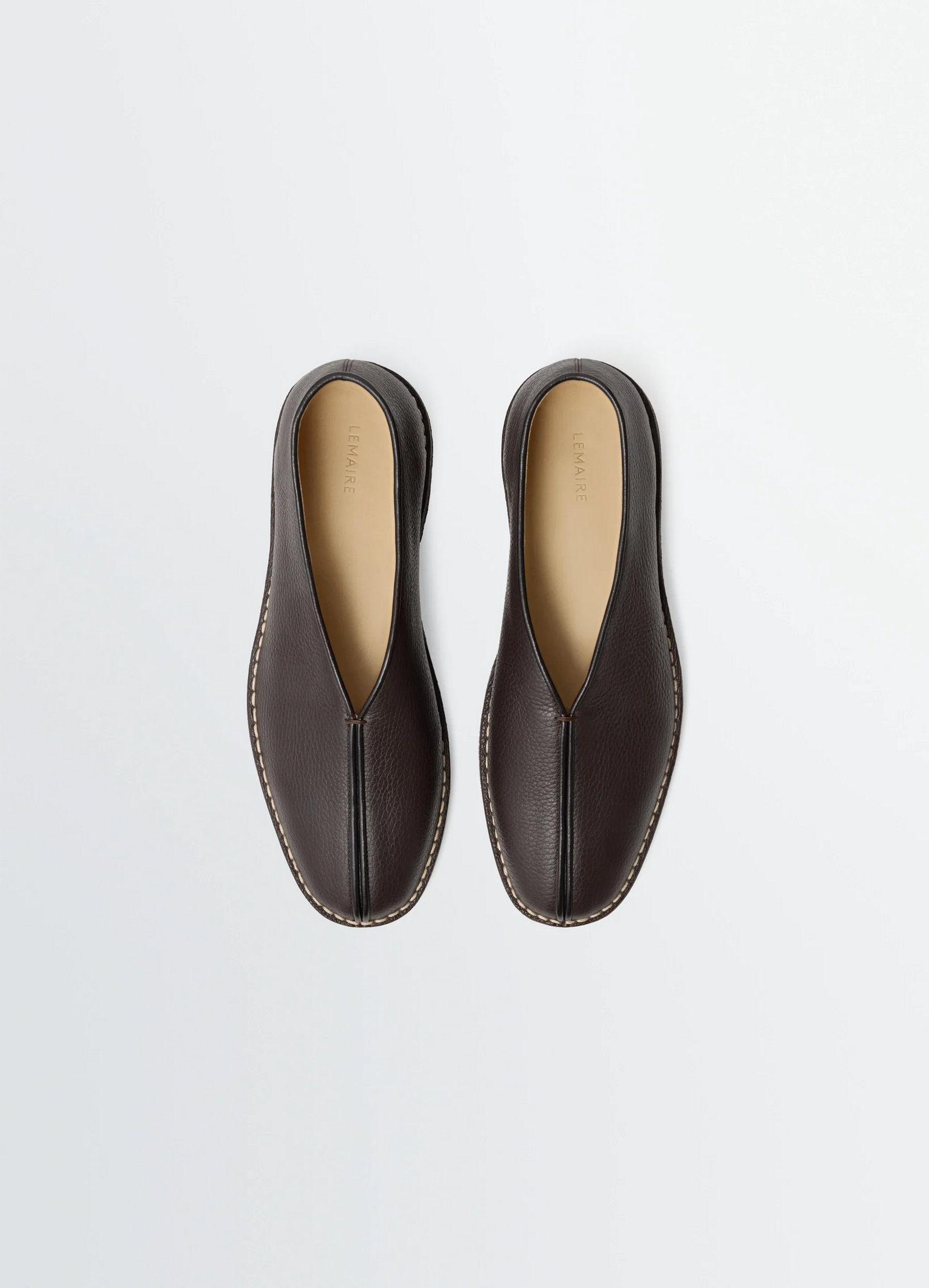 Lemaire piped crepe slippers in leather, product shot, top view neutral insole contrast